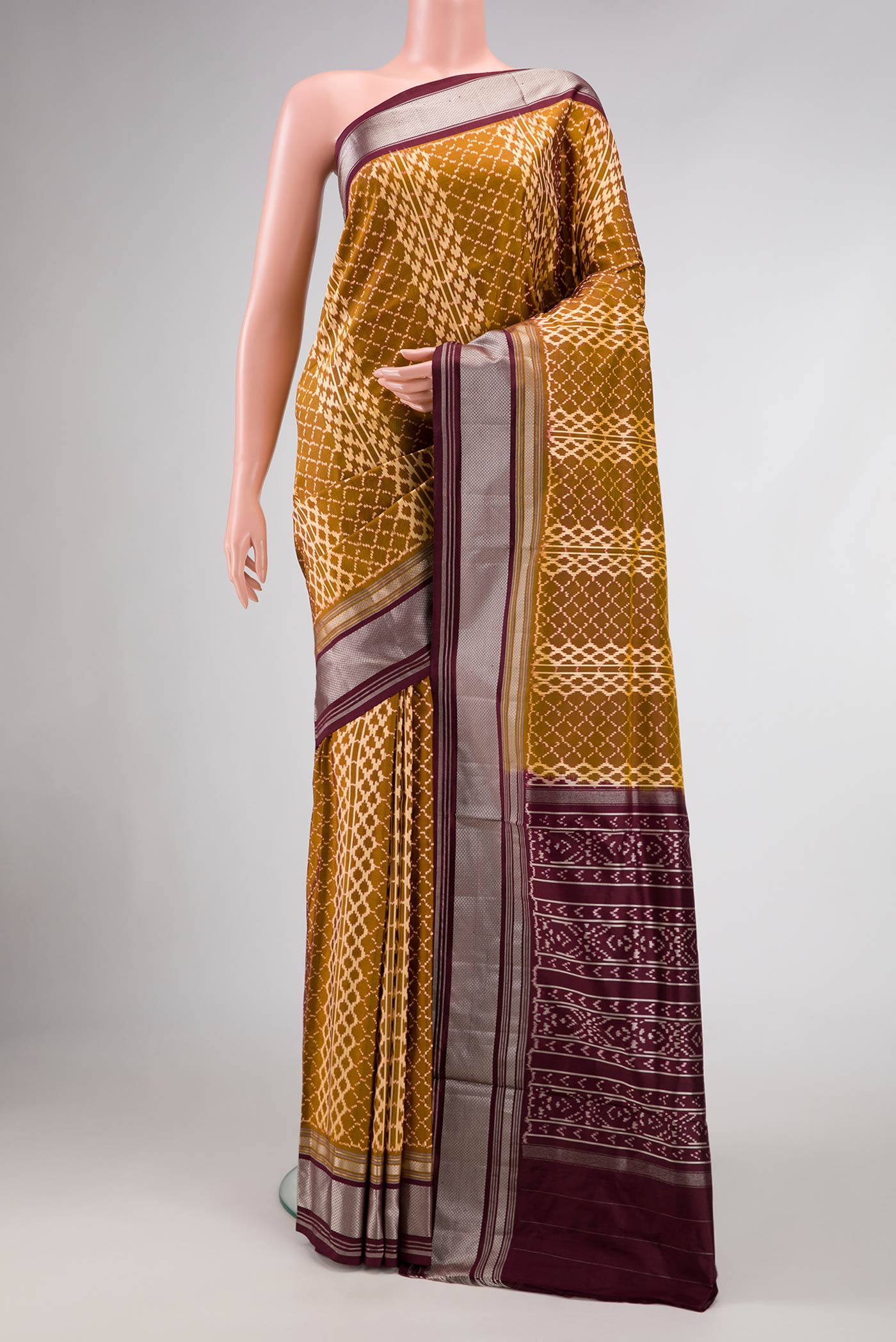 Mehandi Green Dual Tone Double Ikat Saree with Ikat Print on the body and Zari Border.  displayed on a mannequin