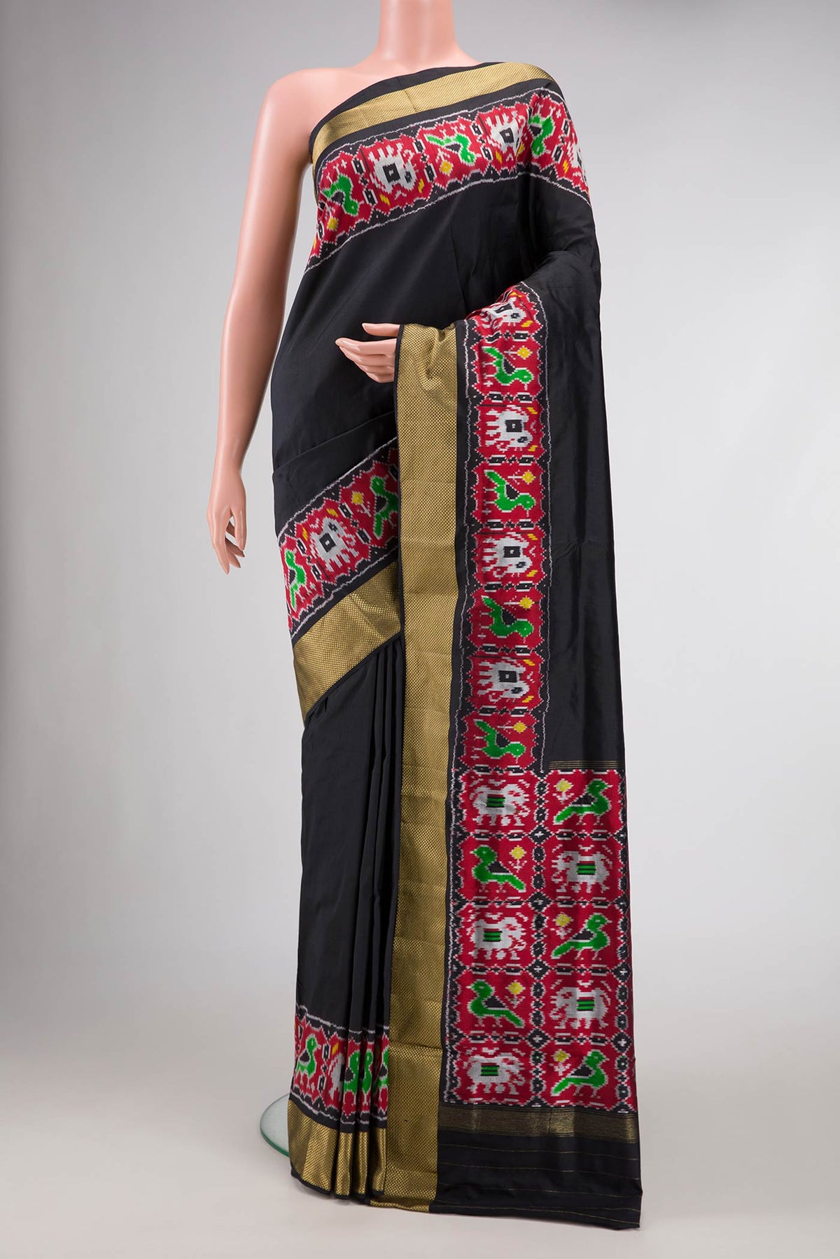 Black Dual Tone Double Ikat Saree with Plain Body and Ikat Border.  displayed on a mannequin