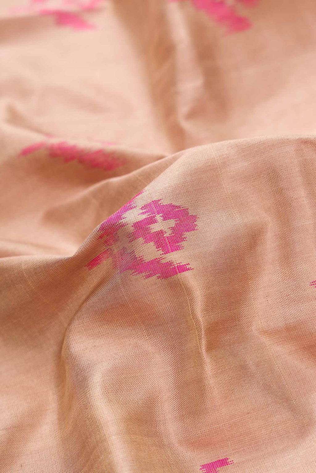 Close up of Beige Dual Tone Double Ikat Saree with Ikat Print on the body and Ikat Border.  displaying folds