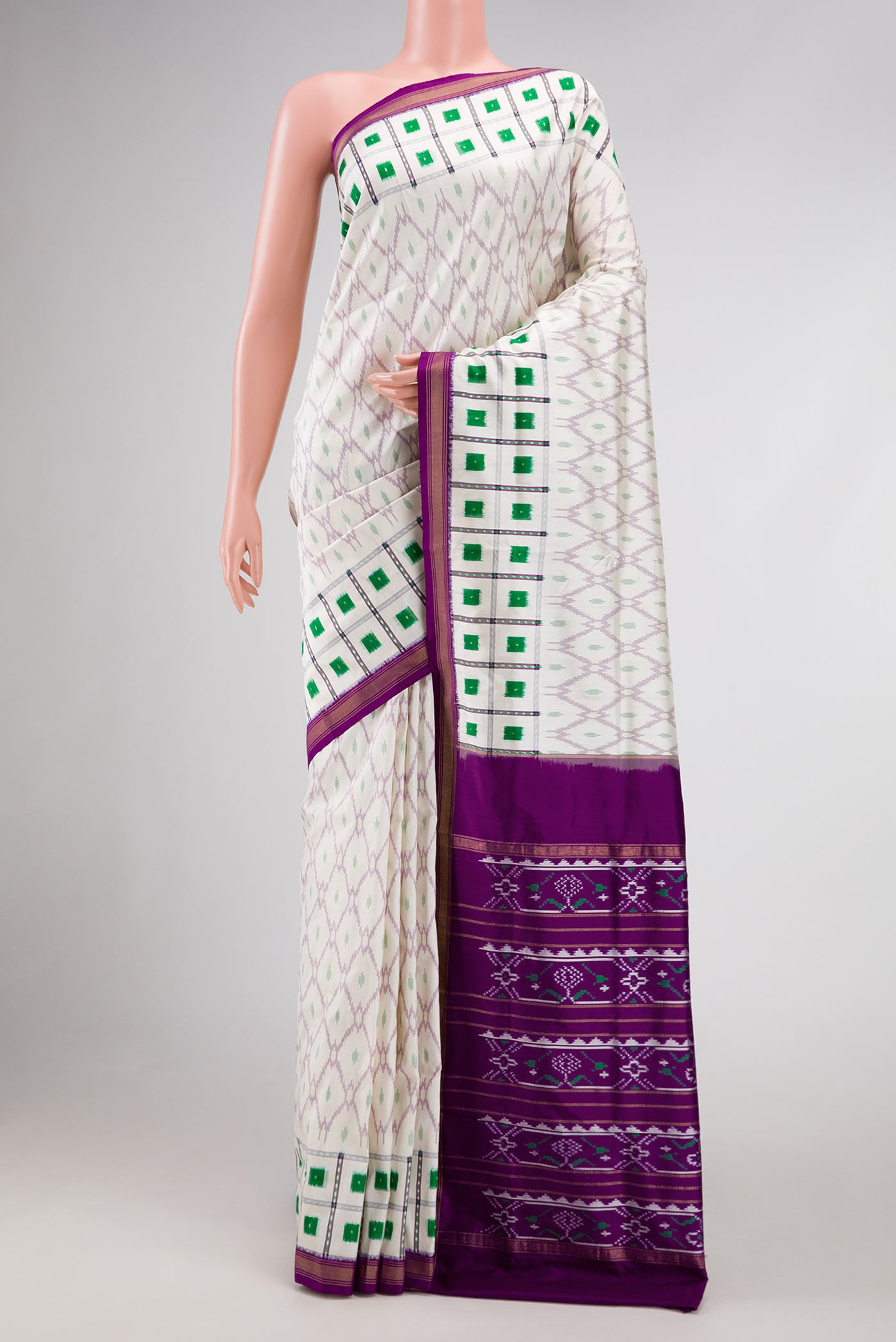 Off White Dual Tone Double Ikat Saree with Ikat Print on the body and Ikat Border displayed on a mannequin