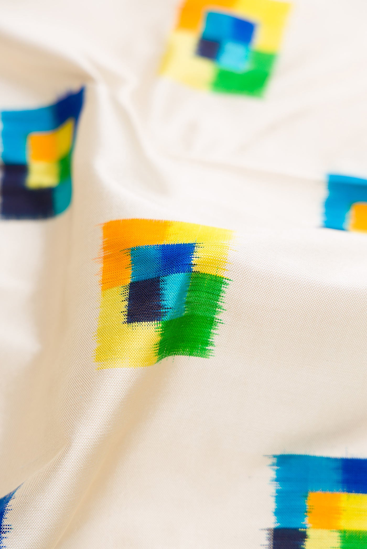 Close up of Off White Pochampally Silk Saree with Pure Ikat on the body and Zari Border displaying folds