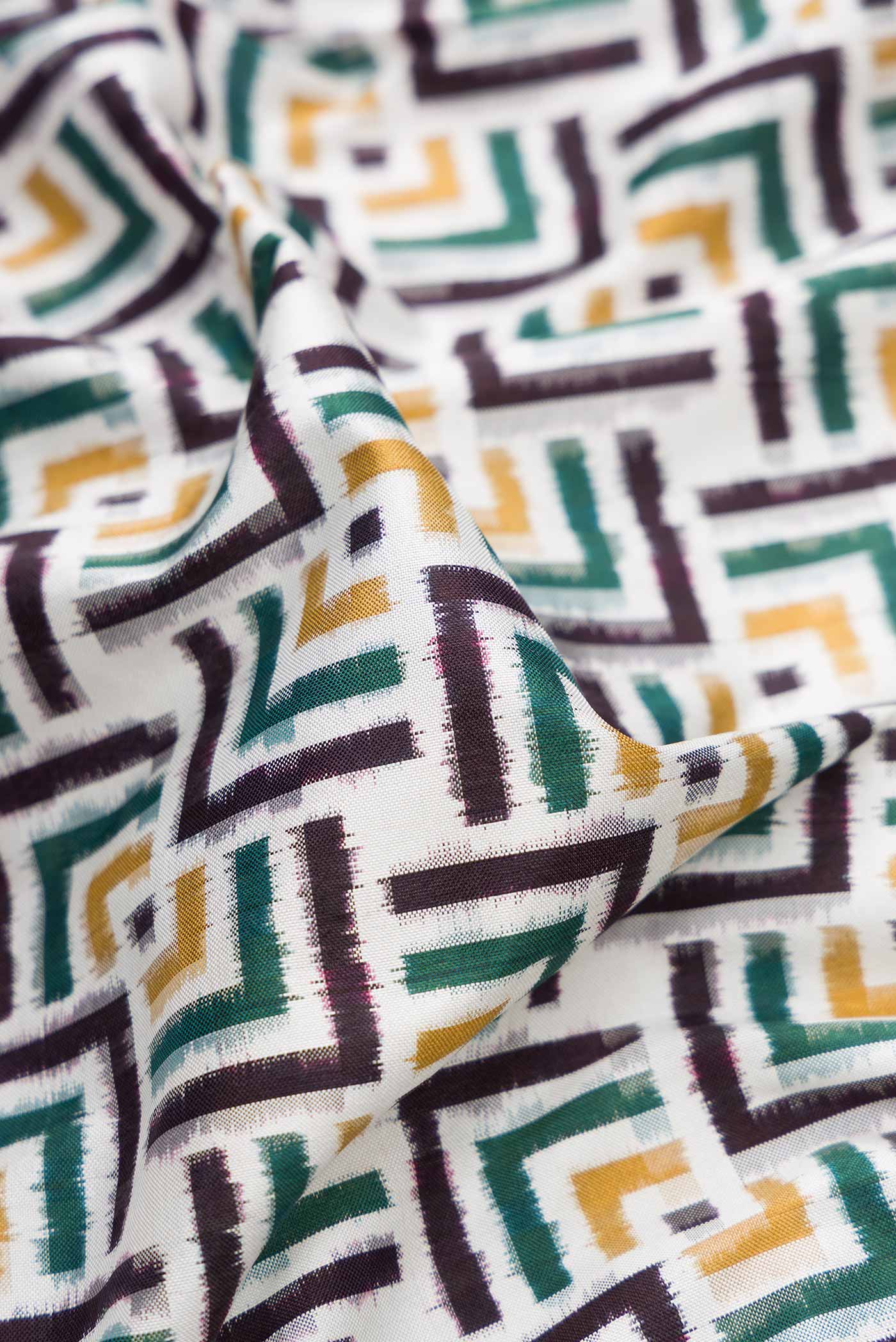 Close up of Off White Pochampally Silk Saree with Pure Ikat on the body and Plain Border displaying folds