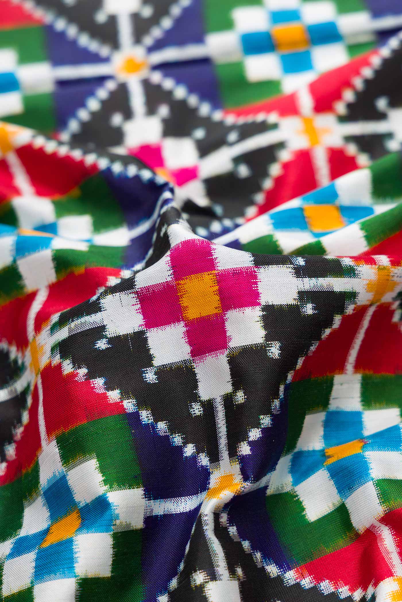 Close up of Multi Color Pochampally Silk Saree with Pure Ikat on the body and Zari Border displaying folds