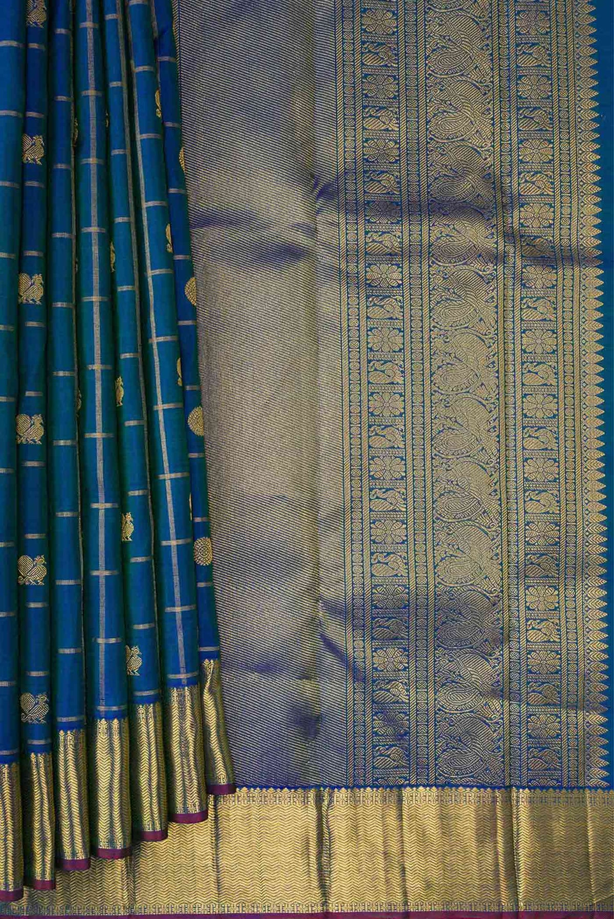 Pleats and pallu of Pure Silk Pure Zari Peacock Blue Dual Tone Kanjivaram Saree with Checked design on the body and Zari Border. 