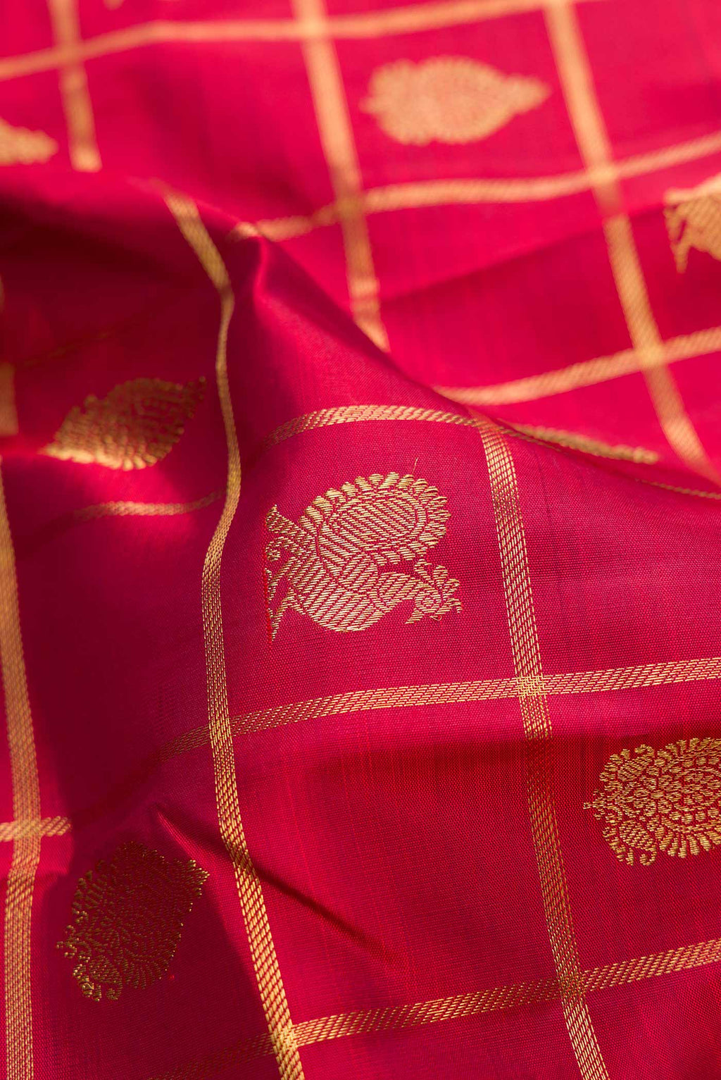 Close up of Pure Silk Pure Zari Maroon Dual Tone Kanjivaram Saree with Checked design on the body and Zari Border.  displaying folds