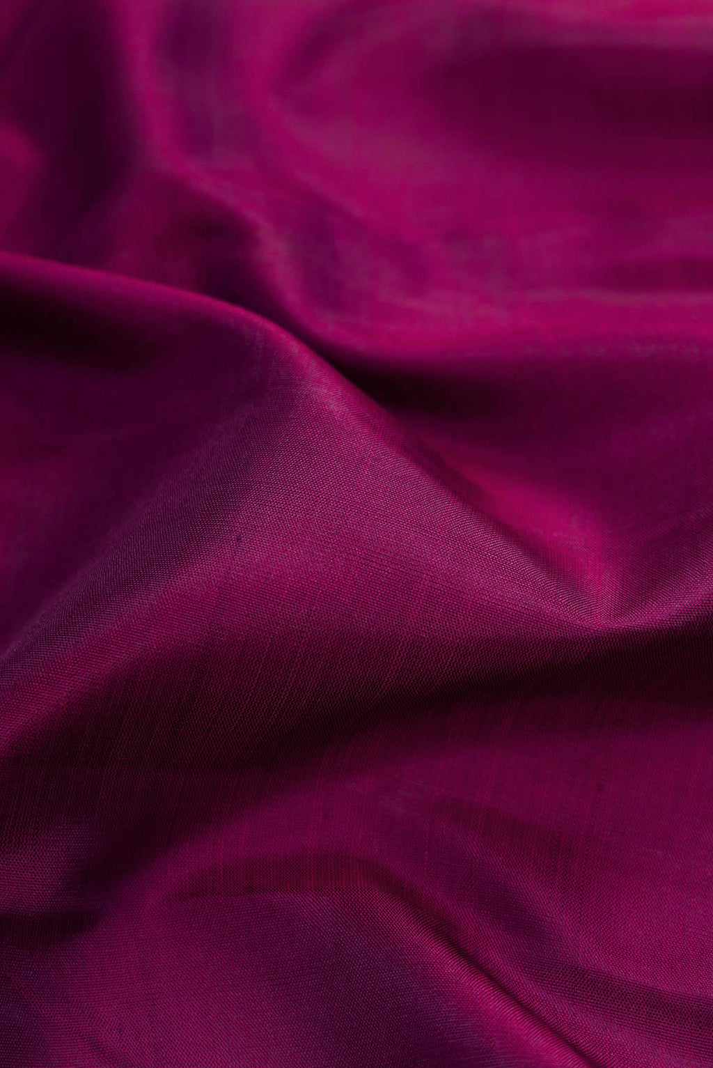 Close up of Maroon Dual Tone Kanchipuram Silk Saree with Plain Body and Zari Border.  displaying folds