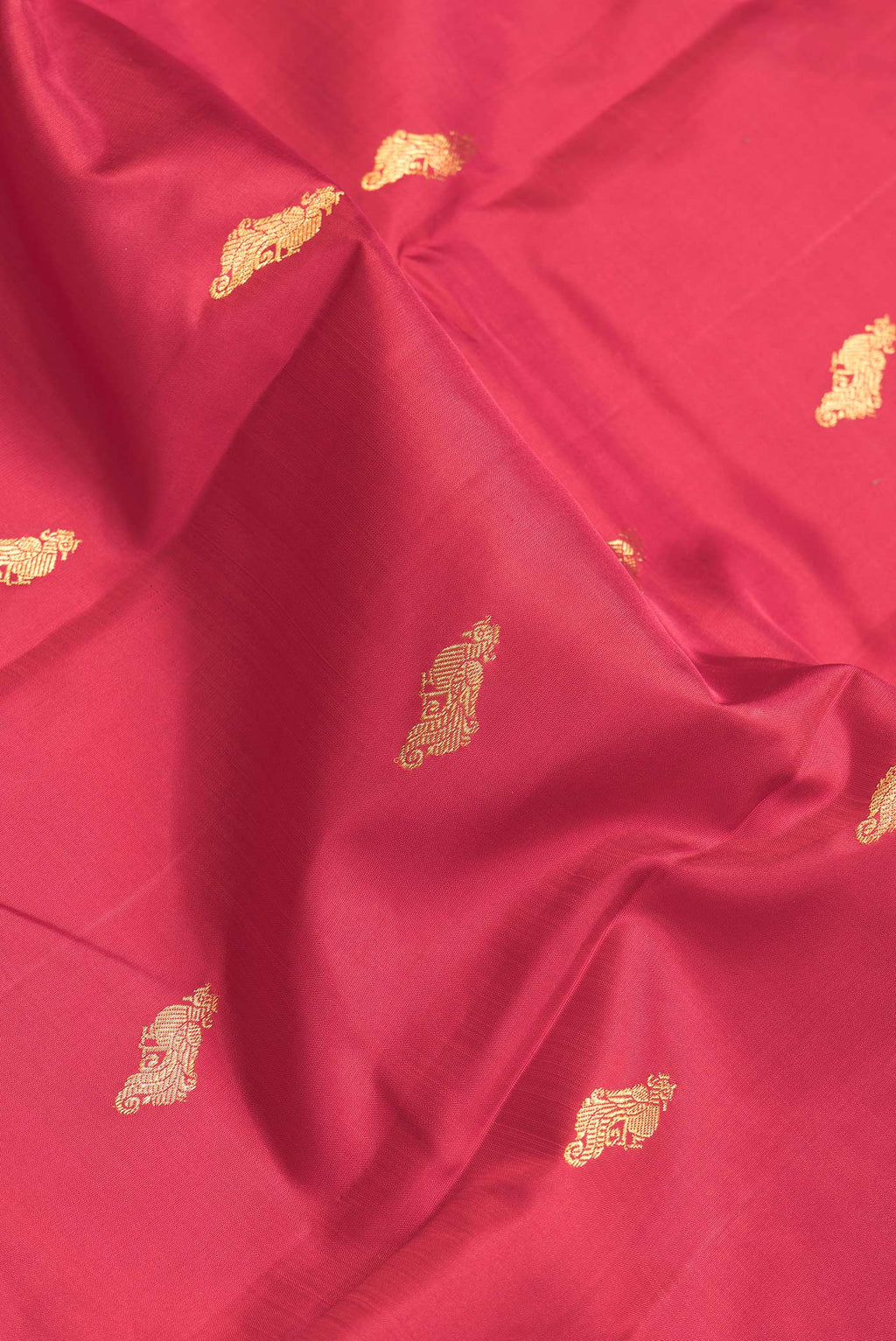 Close up of Maroon Dual Tone Kanchipuram Silk Saree with Zari Butta on the body and Zari Border.  displaying folds