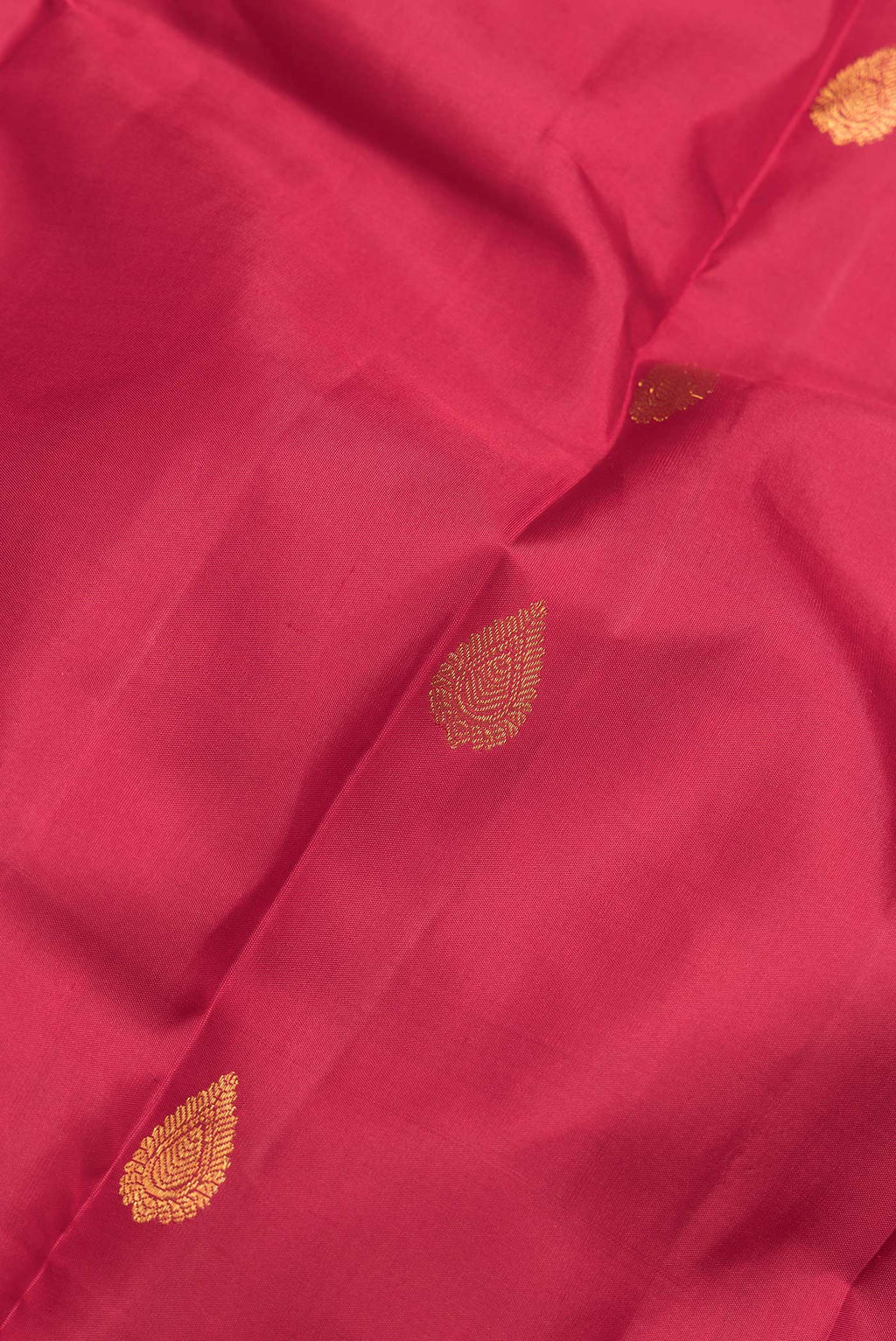 Close up of Maroon Dual Tone Kanchipuram Silk Saree with Zari Butta on the body and Zari Border.  displaying folds