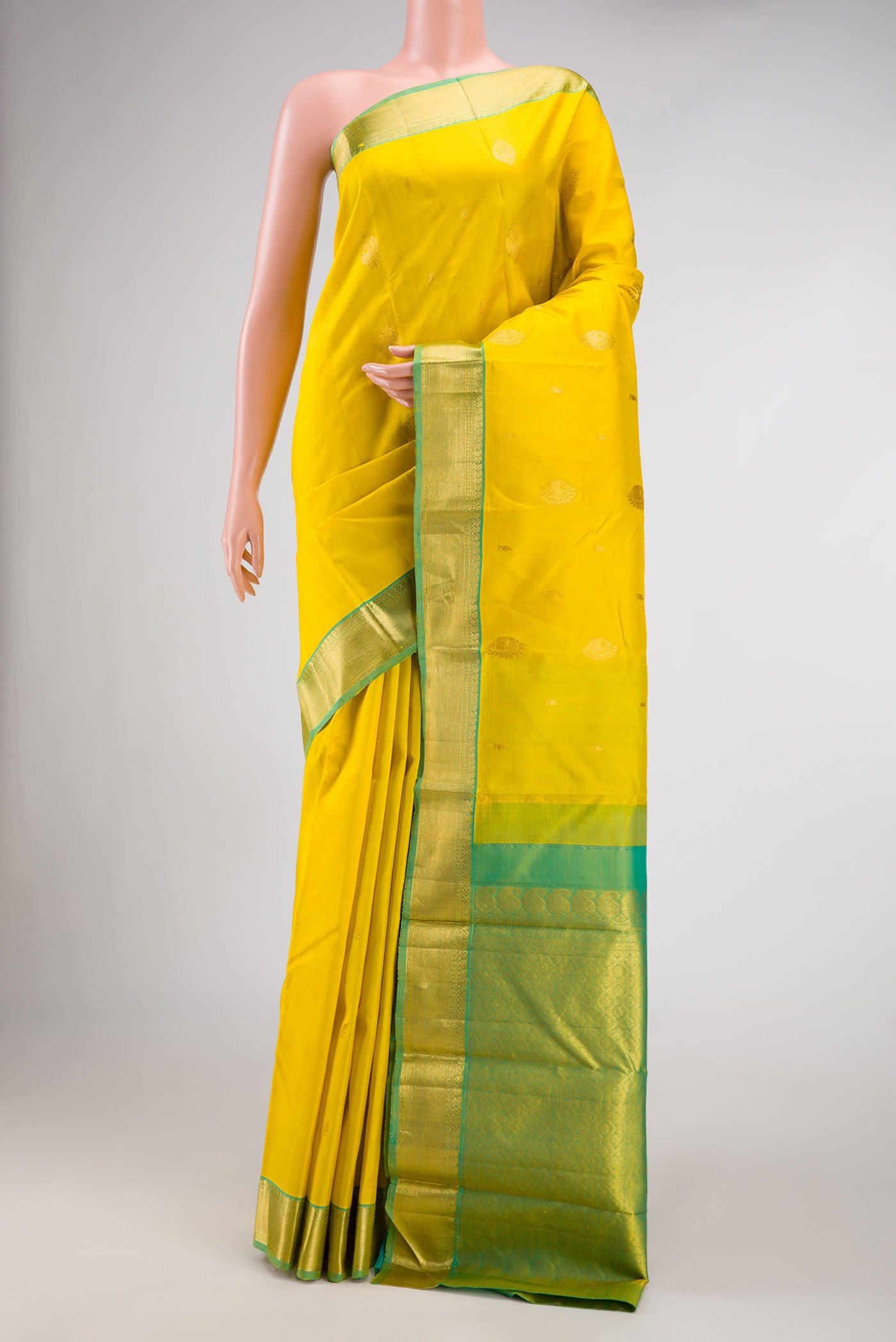 Lemon Yellow Dual Tone Kanjivaram Silk Saree with Zari Butta on the body and Zari Border.  displayed on a mannequin