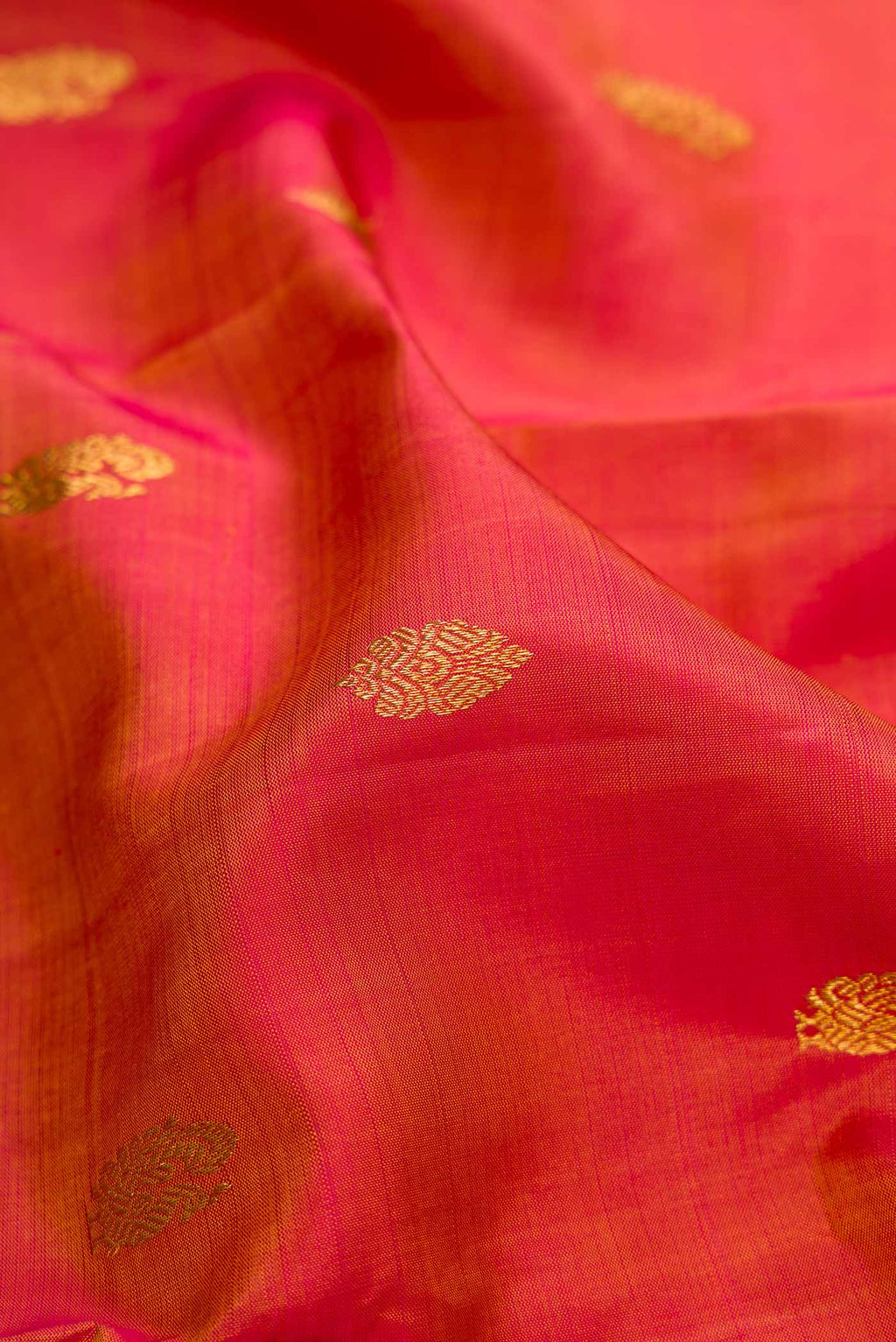 Close up of Mustard Dual Tone Kanjivaram Silk Saree with Zari Butta on the body and Zari Border.  displaying folds