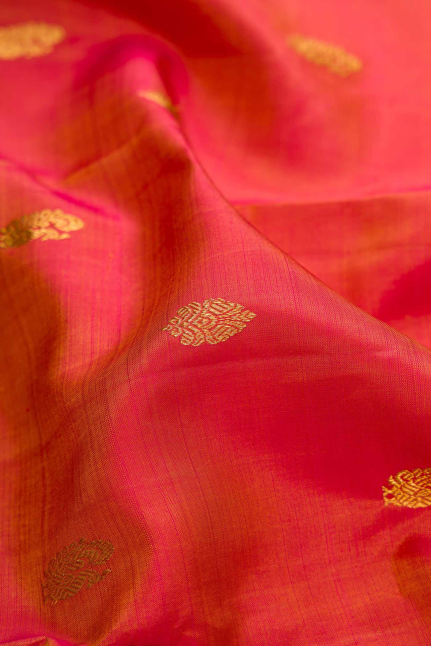 Close up of Mustard Dual Tone Kanjivaram Silk Saree with Zari Butta on the body and Zari Border.  displaying folds