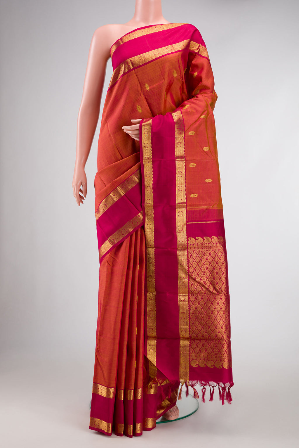 Mustard Dual Tone Kanjivaram Silk Saree with Zari Butta on the body and Zari Border.  displayed on a mannequin