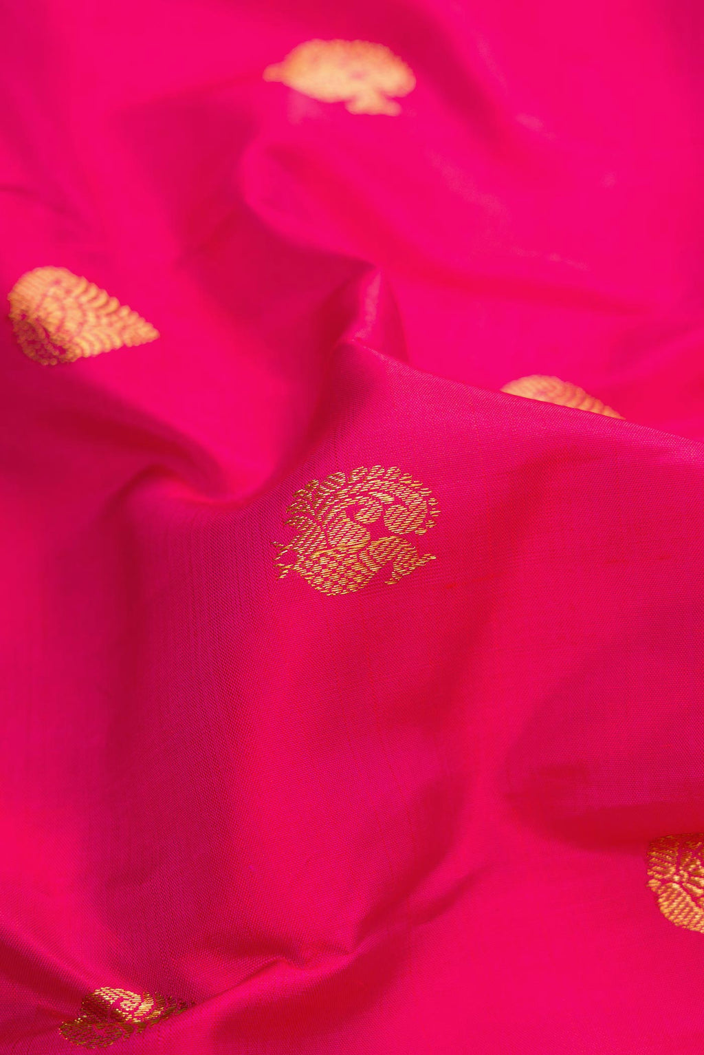 Close up of Pink Dual Tone Kanjivaram Silk Saree with Zari Butta on the body and Zari Border.  displaying folds