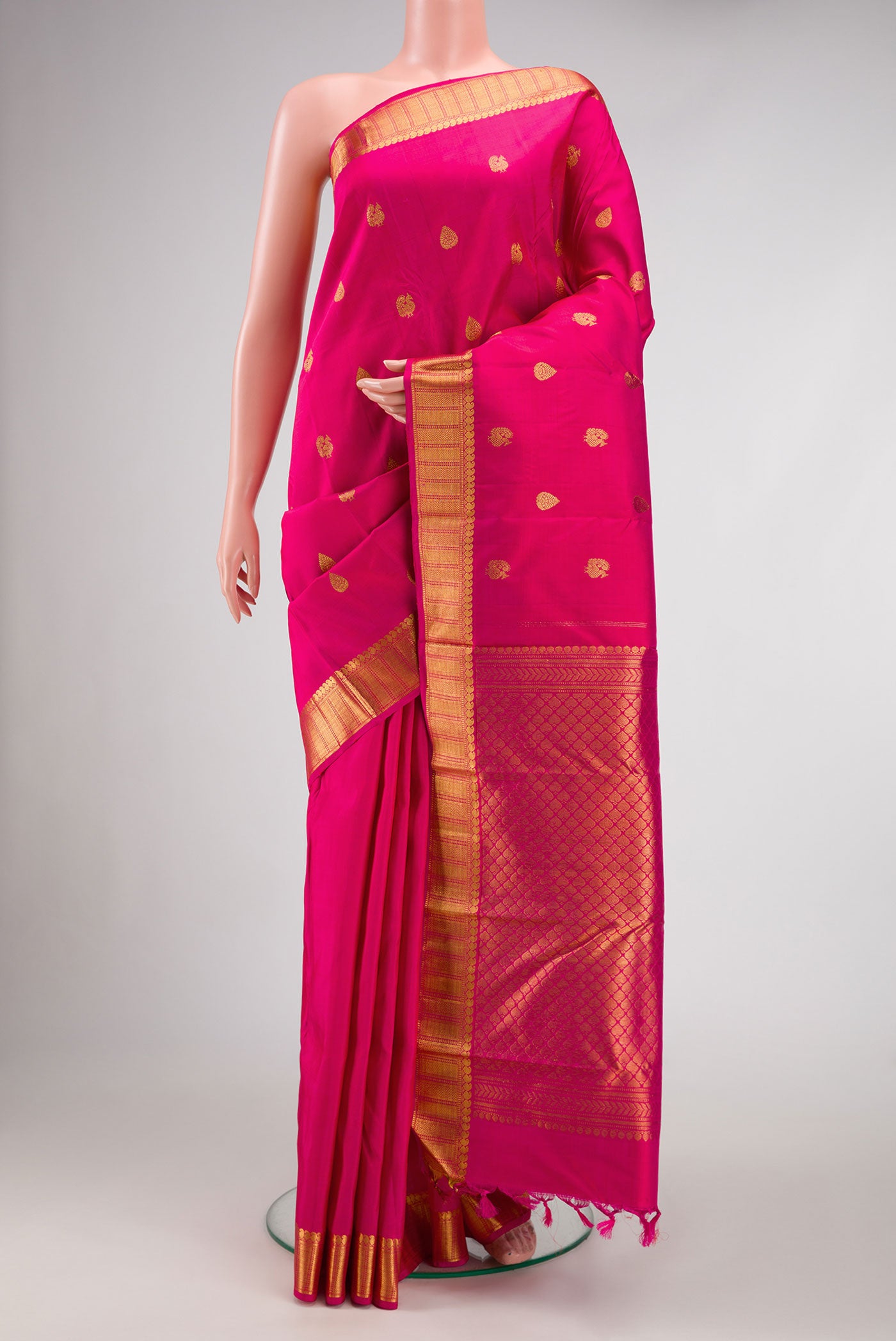 Pink Dual Tone Kanjivaram Silk Saree with Zari Butta on the body and Zari Border.  displayed on a mannequin
