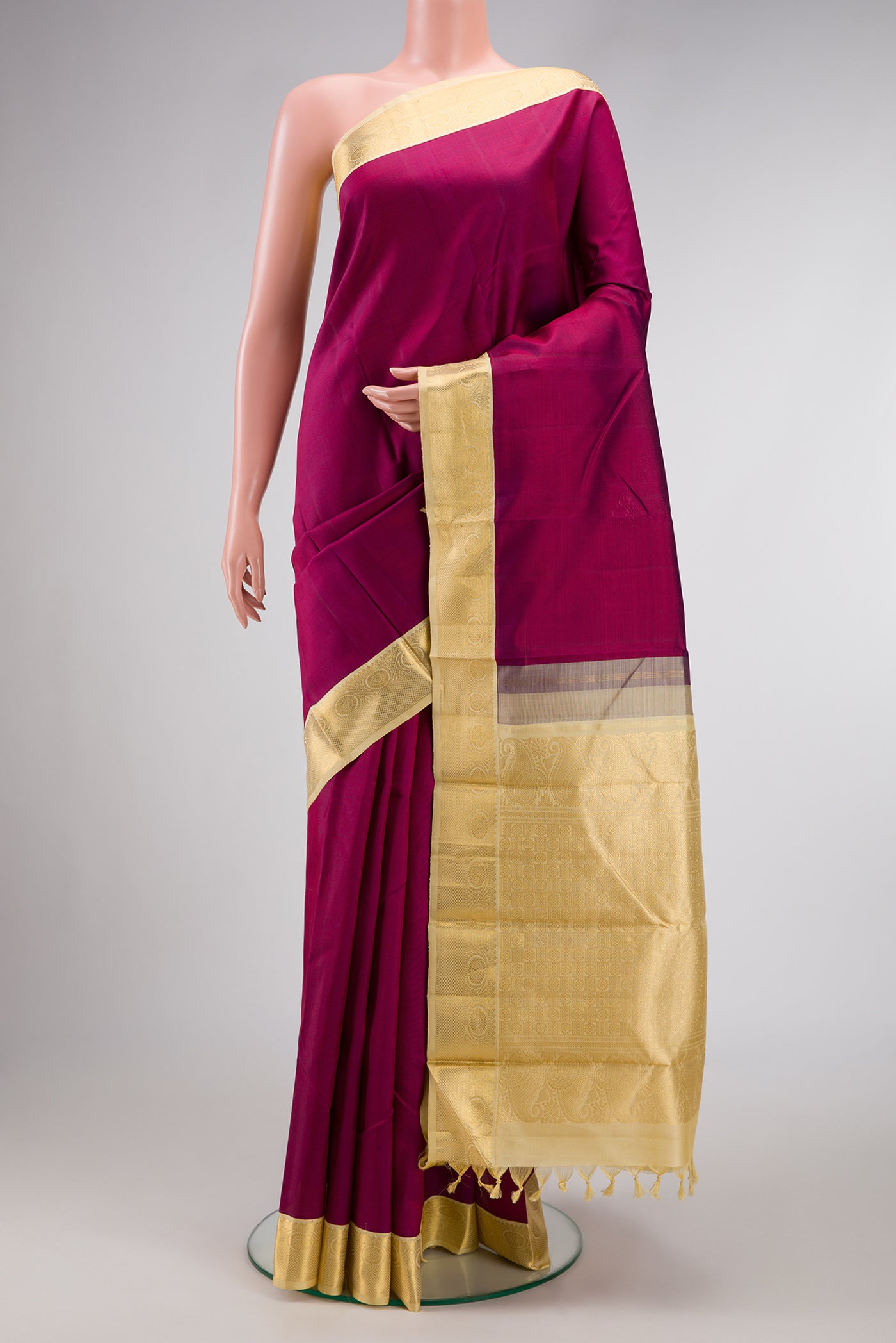 Burgundy Dual Tone Kanjivaram Silk Saree with Plain Body and Zari Border.  displayed on a mannequin