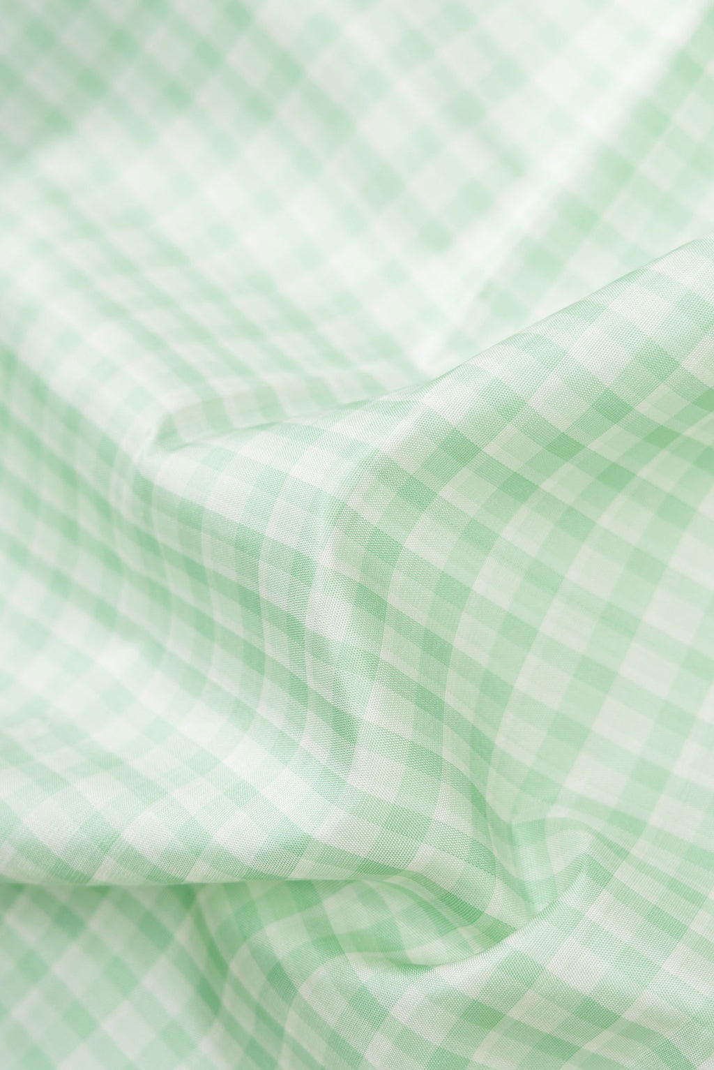 Close up of Pista Green Dual Tone Kanjivaram Silk Saree with Checked design on the body and Zari Border.  displaying folds