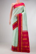 Pista Green Dual Tone Kanjivaram Silk Saree with Checked design on the body and Zari Border.  displayed on a mannequin