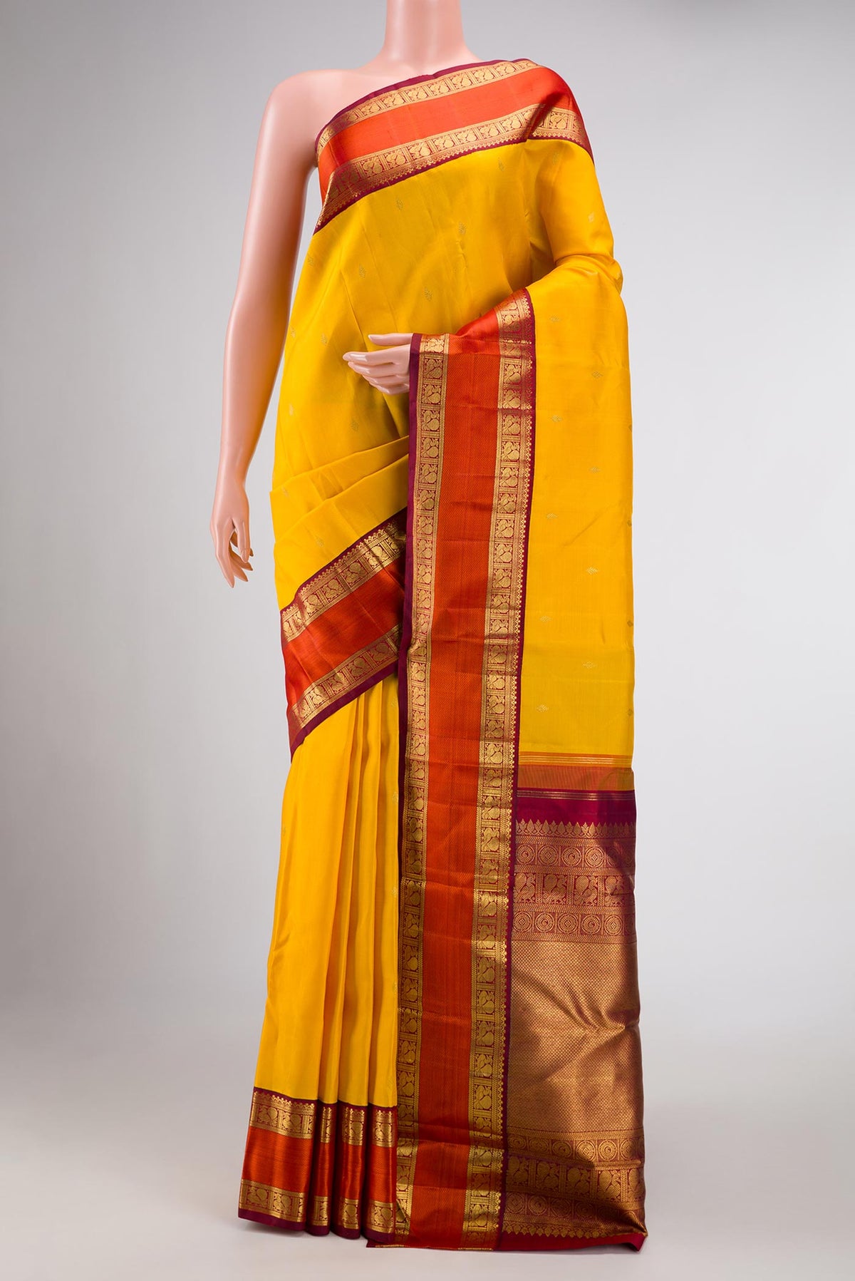 Pure Silk Pure Zari Mustard Dual Tone Kanchipuram Saree with Zari Butta on the body and Zari And Thread Border displayed on a mannequin