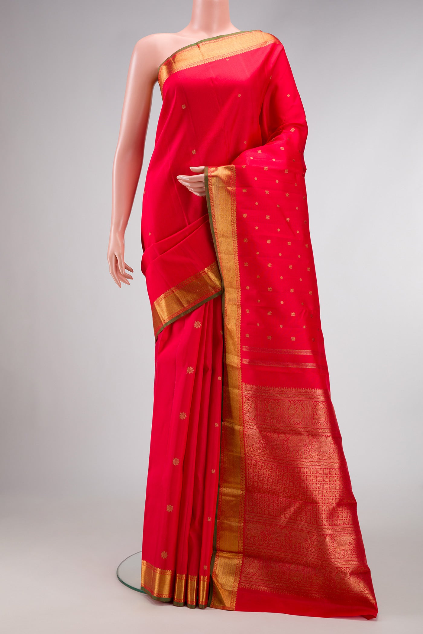 Pure Silk Pure Zari Red Dual Tone Kanchipuram Saree with Zari Butta on the body and Zari Border.  displayed on a mannequin
