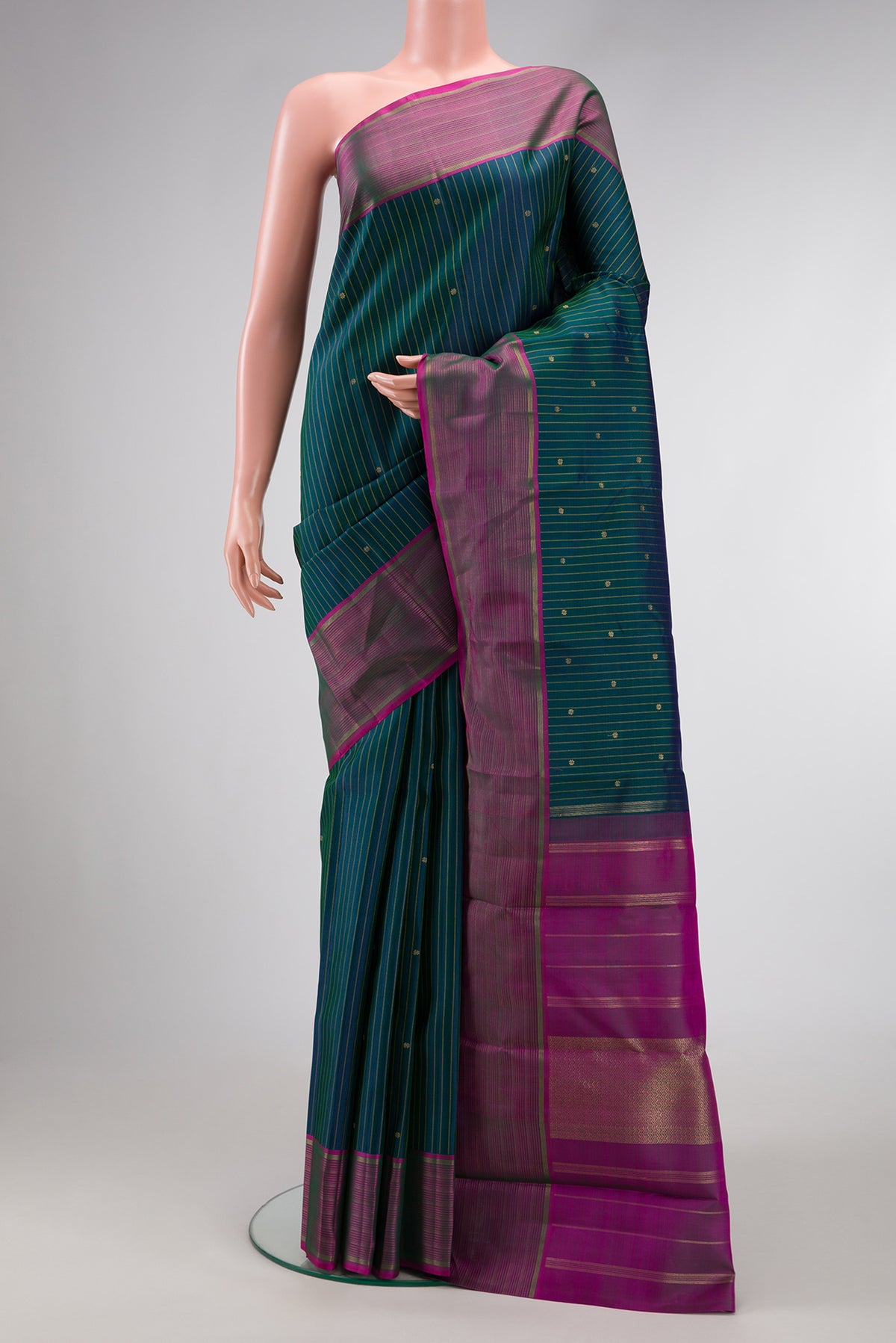 Pure Silk Pure Zari Bottle Green Dual Tone Kanchipuram Saree with Checked design on the body and Zari Border.  displayed on a mannequin