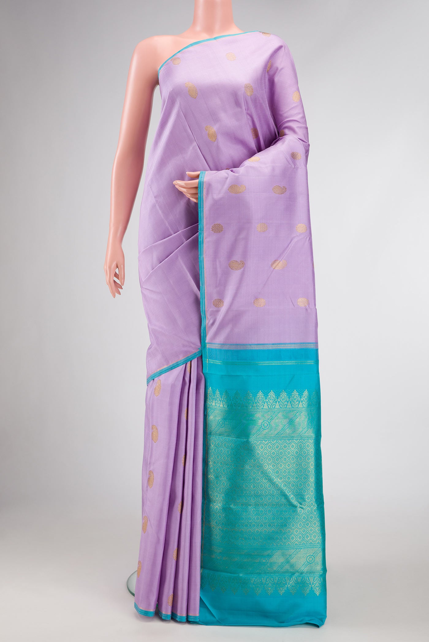 Pure Silk Pure Zari Lavender Dual Tone Kanchipuram Saree with Zari Butta on the body and Thin Zari Line.  displayed on a mannequin