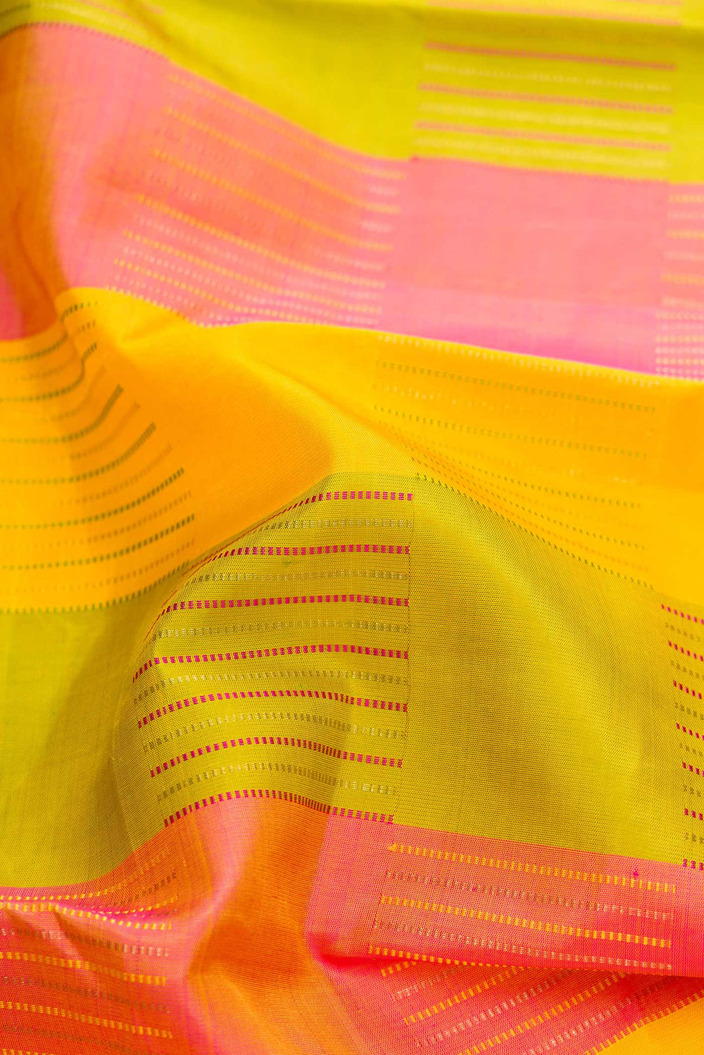 Close up of Pure Silk Pure Zari Green, Pink and Yellow Color Kanchipuram Saree with Stripes on the body and Without Border.  displaying folds