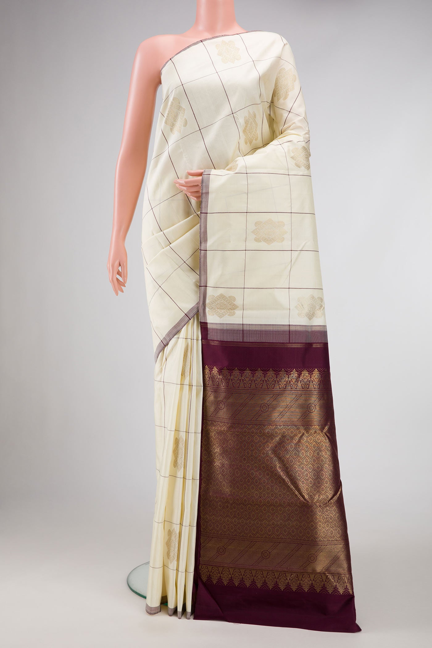 Pure Silk Pure Zari Off White Dual Tone Kanjivaram Saree with Checked design on the body and Without Border.  displayed on a mannequin