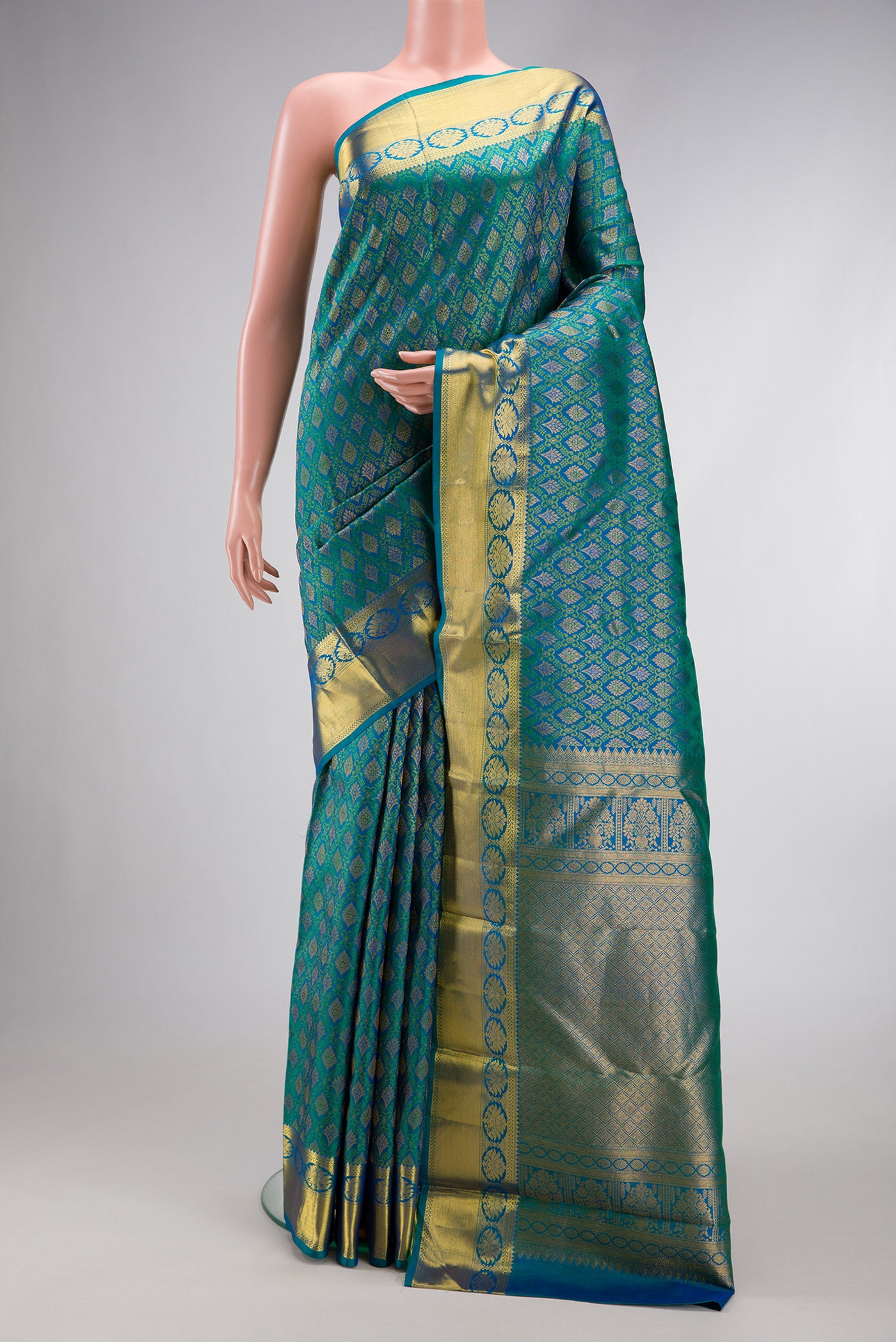 Peacock Blue Dual Tone Kanjivaram Silk Saree with Zari Brocade on the body and Zari Border.  displayed on a mannequin