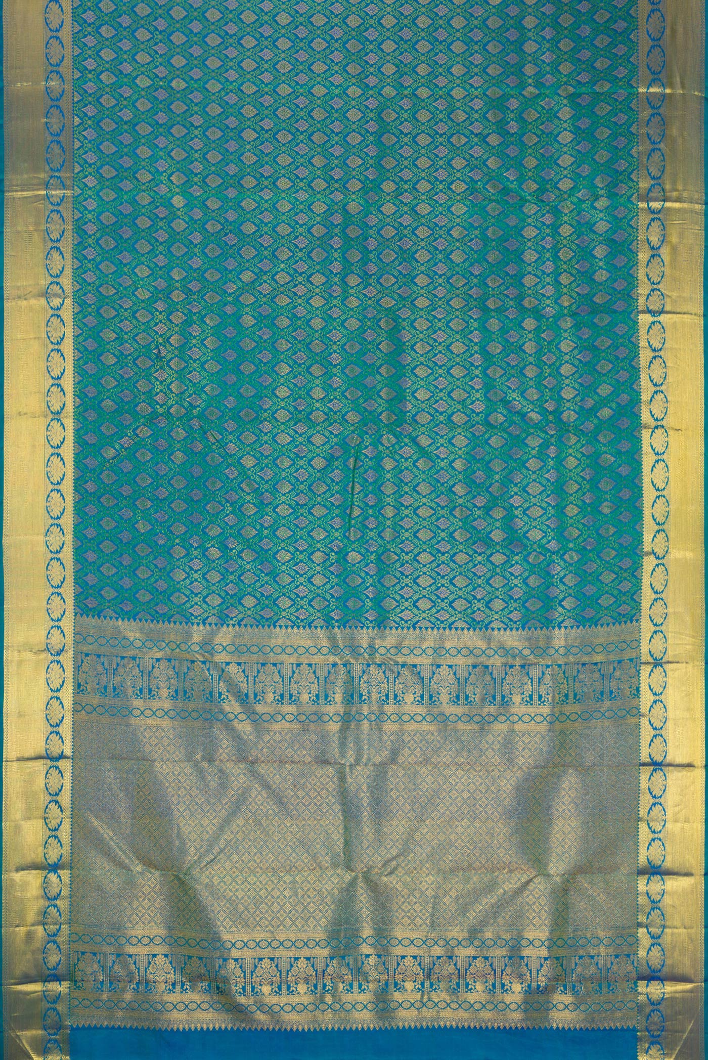 Flat view of Peacock Blue Dual Tone Kanjivaram Silk Saree with Zari Brocade on the body and Zari Border. 