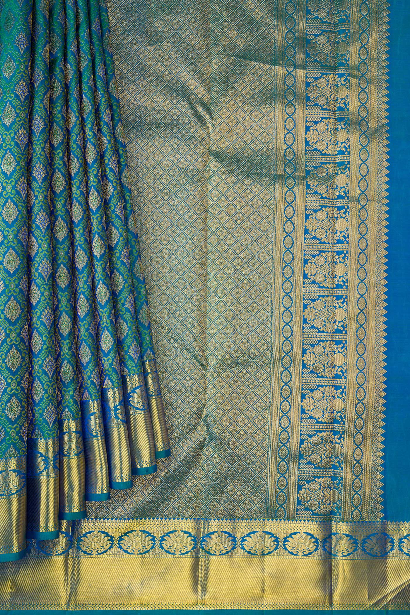 Pleats and pallu of Peacock Blue Dual Tone Kanjivaram Silk Saree with Zari Brocade on the body and Zari Border. 