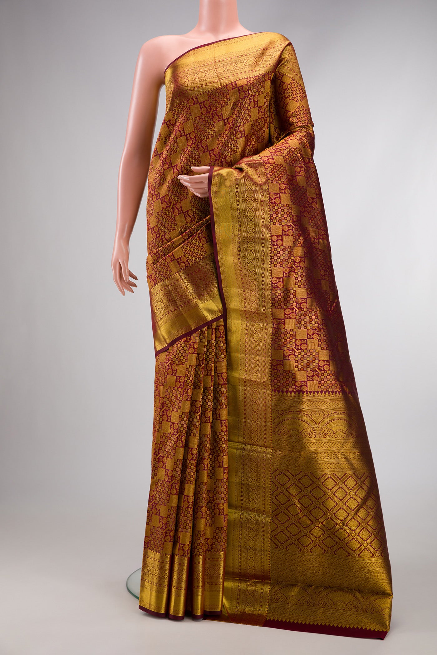 Maroon Dual Tone Kanjivaram Silk Saree with Zari Brocade on the body and Zari Border.  displayed on a mannequin