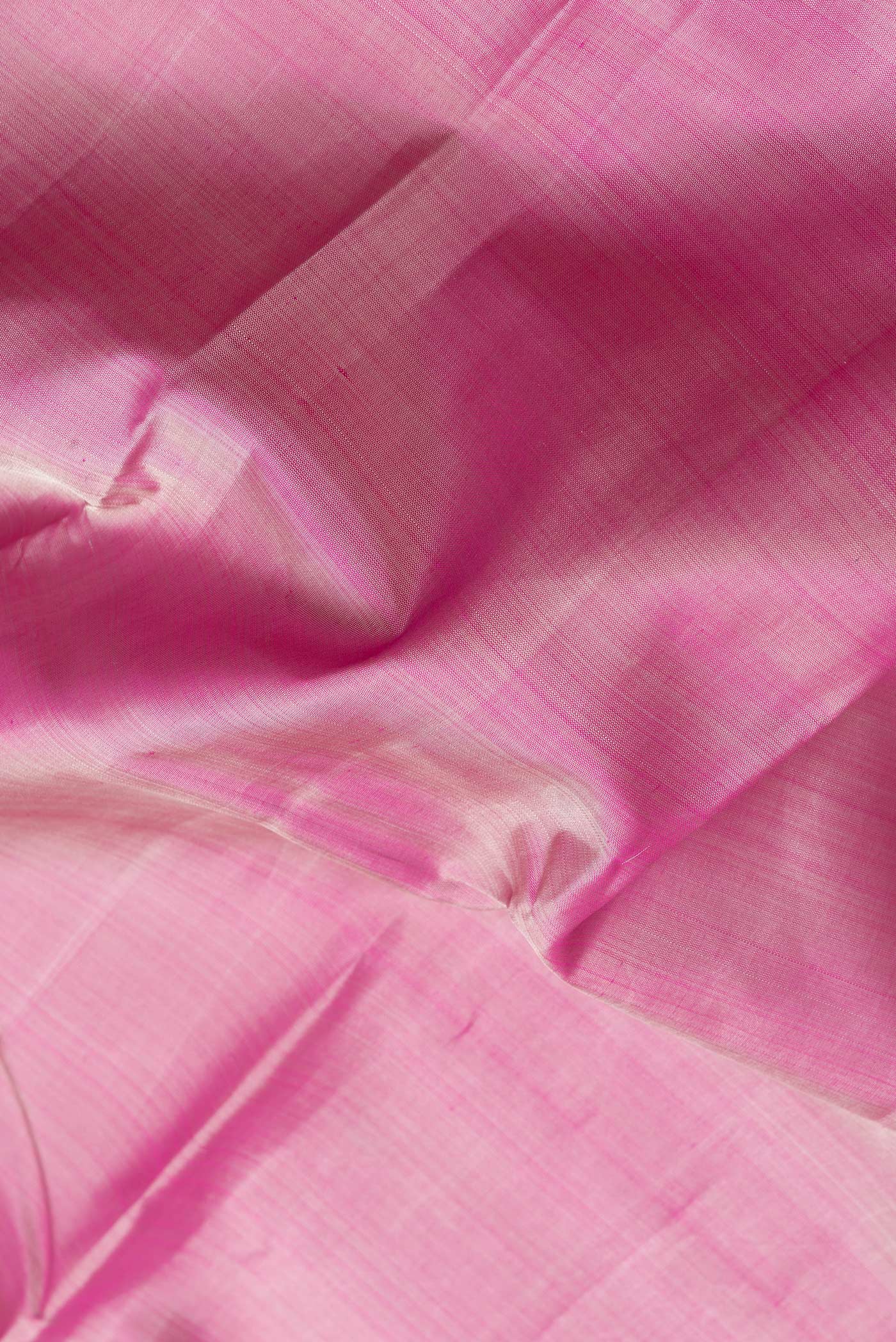 Close up of Pink Dual Tone Kanchipuram Silk Saree with Plain Body and Zari Border.  displaying folds