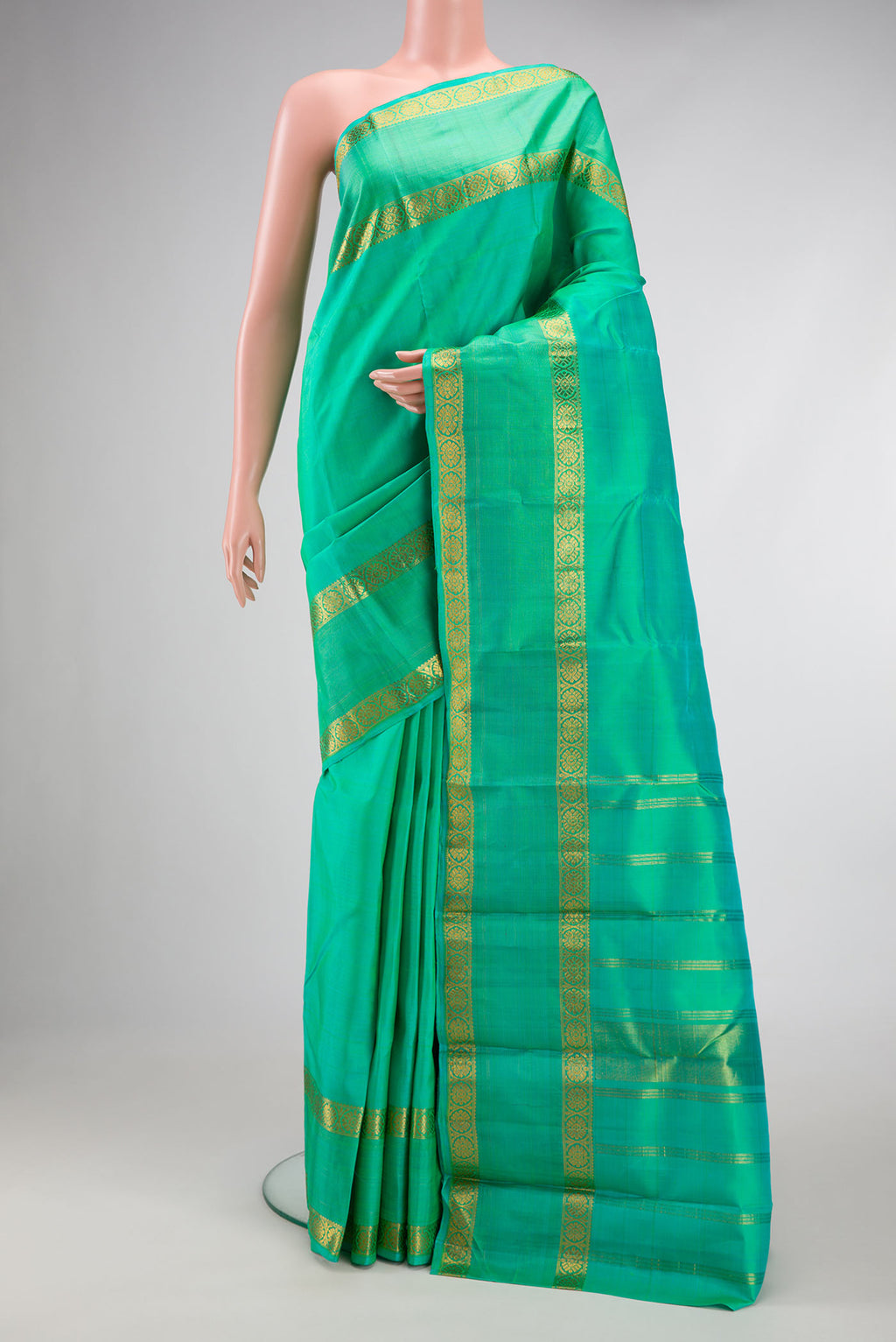 Sea Green Dual Tone Kanchipuram Silk Saree with Plain Body and Zari Border.  displayed on a mannequin
