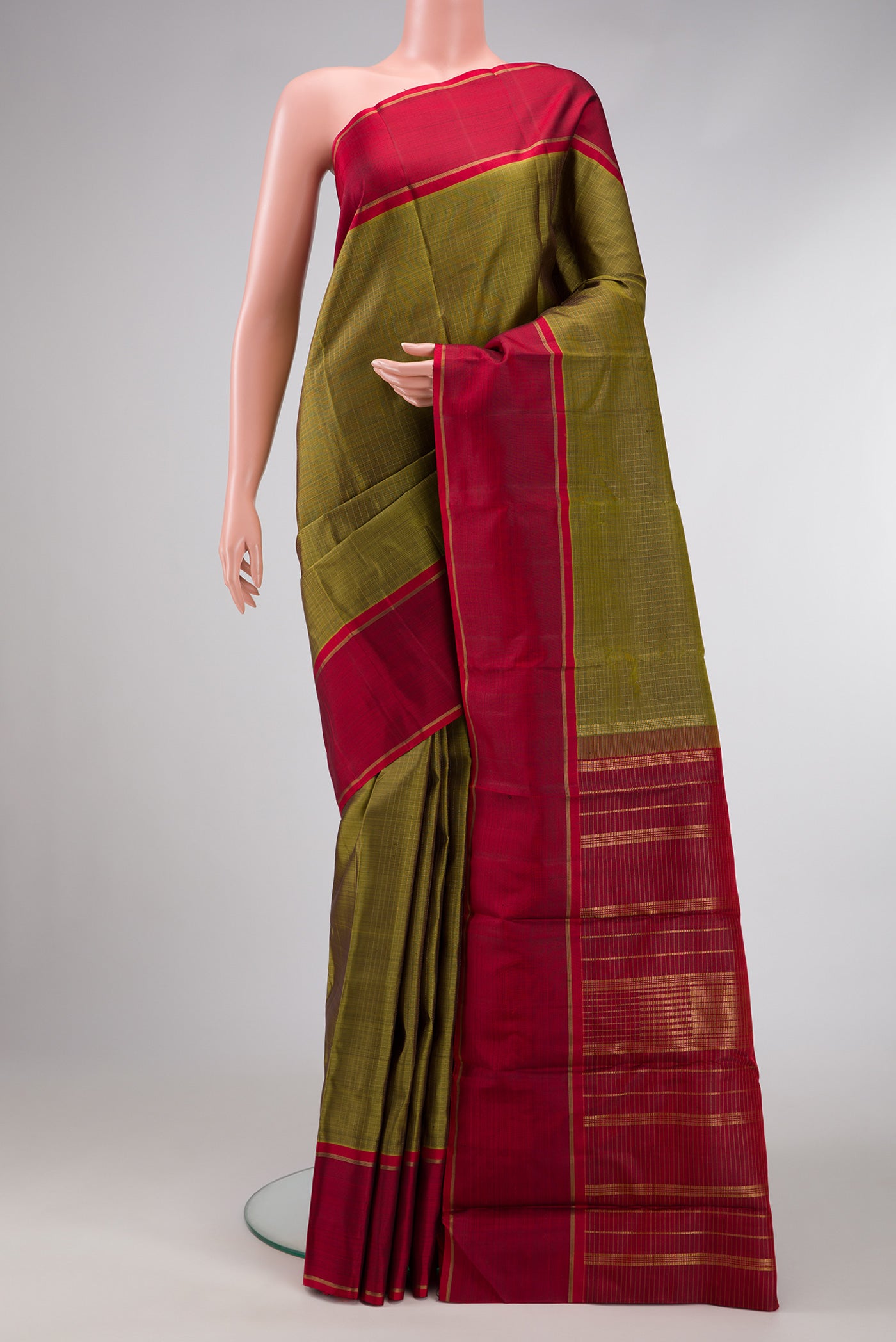Green Dual Tone Kanchipuram Silk Saree with Zari Butta on the body and Zari Border.  displayed on a mannequin