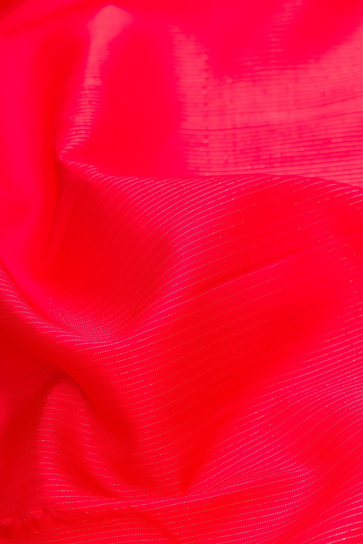 Close up of Pure Silk Pure Zari Red Dual Tone Kanjivaram Saree with Stripes on the body and Without Border.  displaying folds
