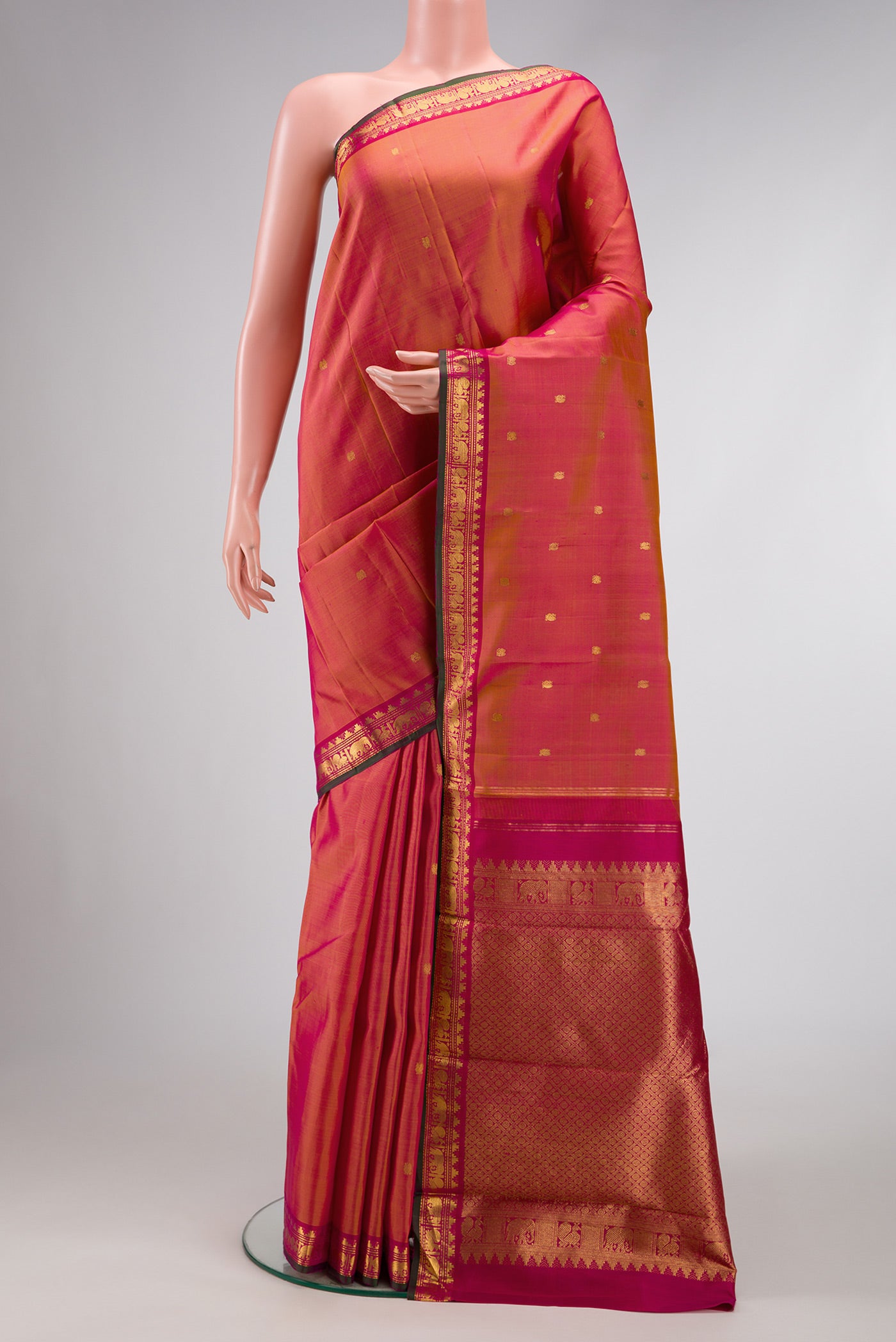 Coral Dual Tone Kanchipuram Silk Saree with Zari Butta on the body and Zari Border.  displayed on a mannequin