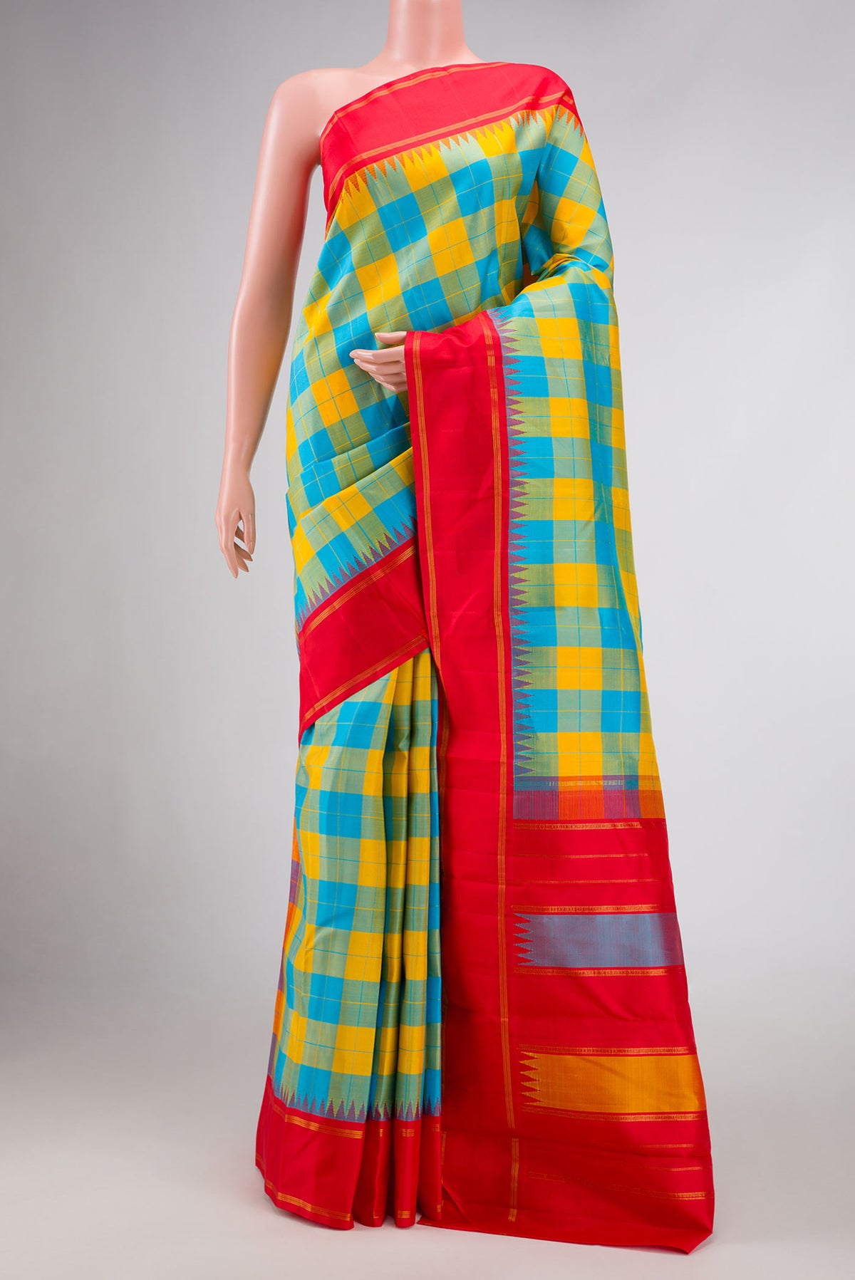 Yellow and Sky Blue Color Kanchipuram Silk Saree with Checked design on the body and Zari Border.  displayed on a mannequin