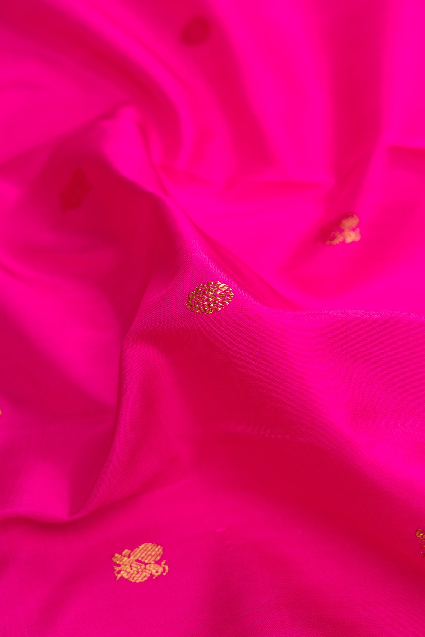 Close up of Pink Dual Tone Kanchipuram Silk Saree with Zari Butta on the body and Zari Border.  displaying folds
