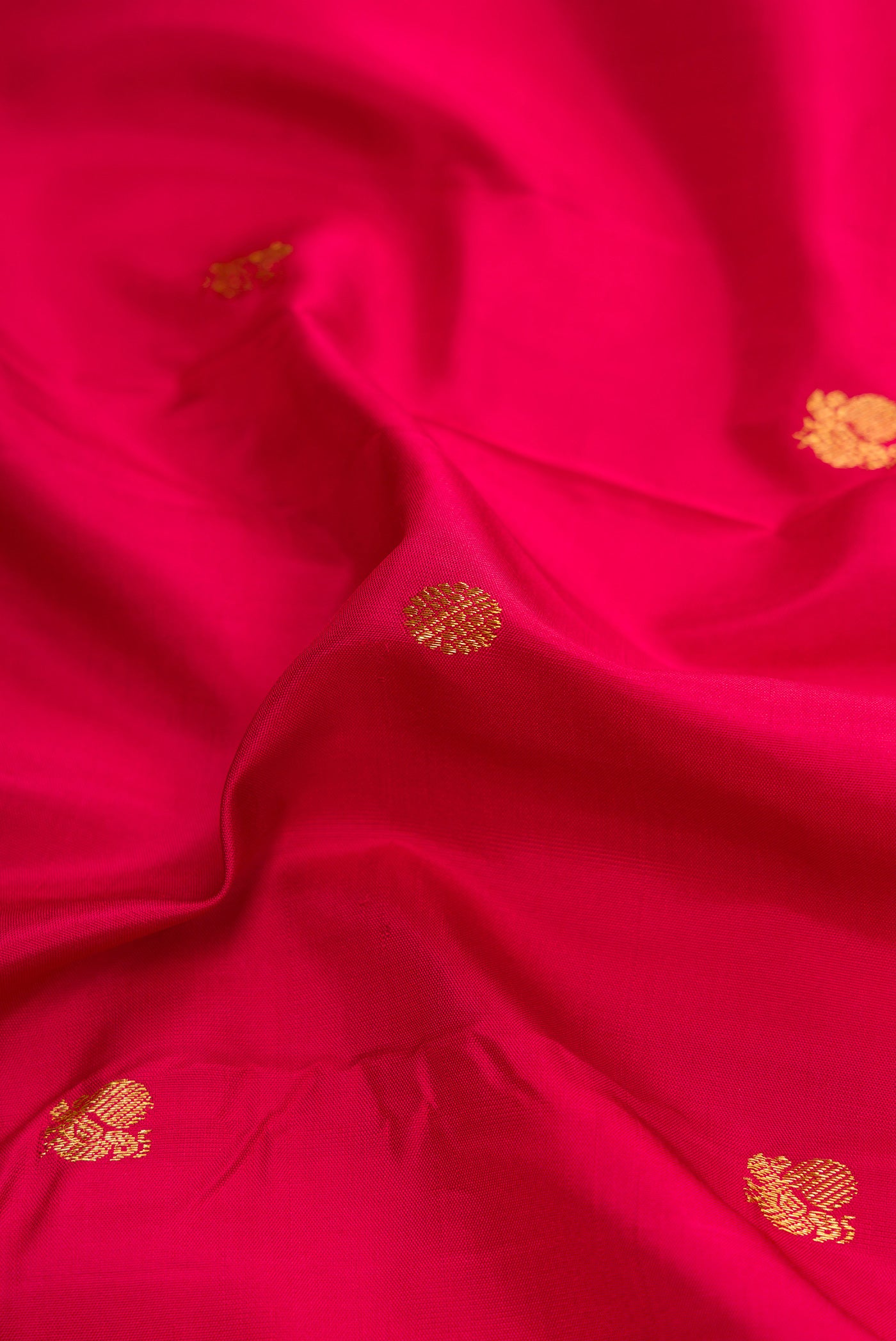 Close up of Maroon Dual Tone Kanchipuram Silk Saree with Zari Butta on the body and Zari Border.  displaying folds