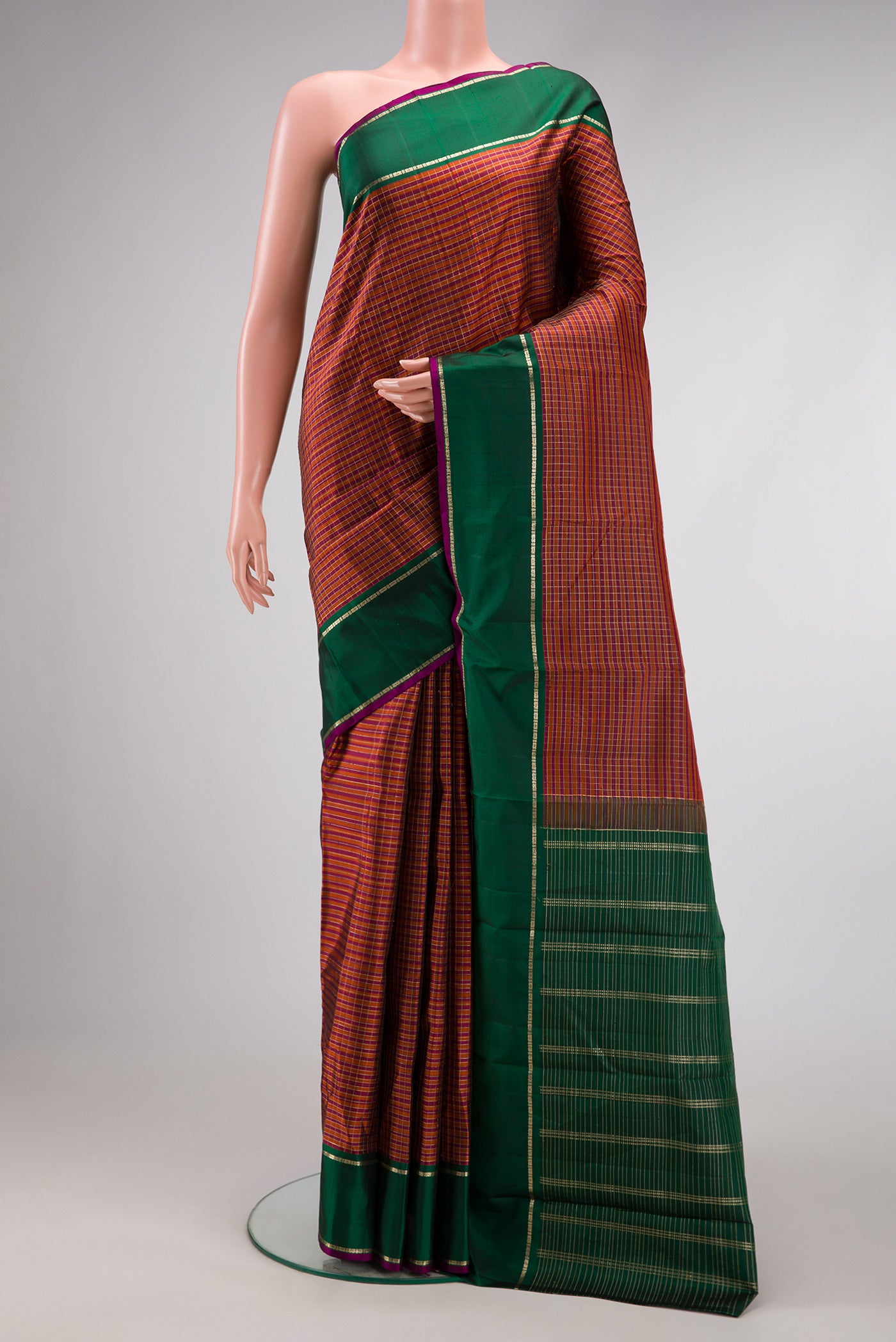 Orange Dual Tone Kanjivaram Silk Saree with Checked design on the body and Zari Border.  displayed on a mannequin