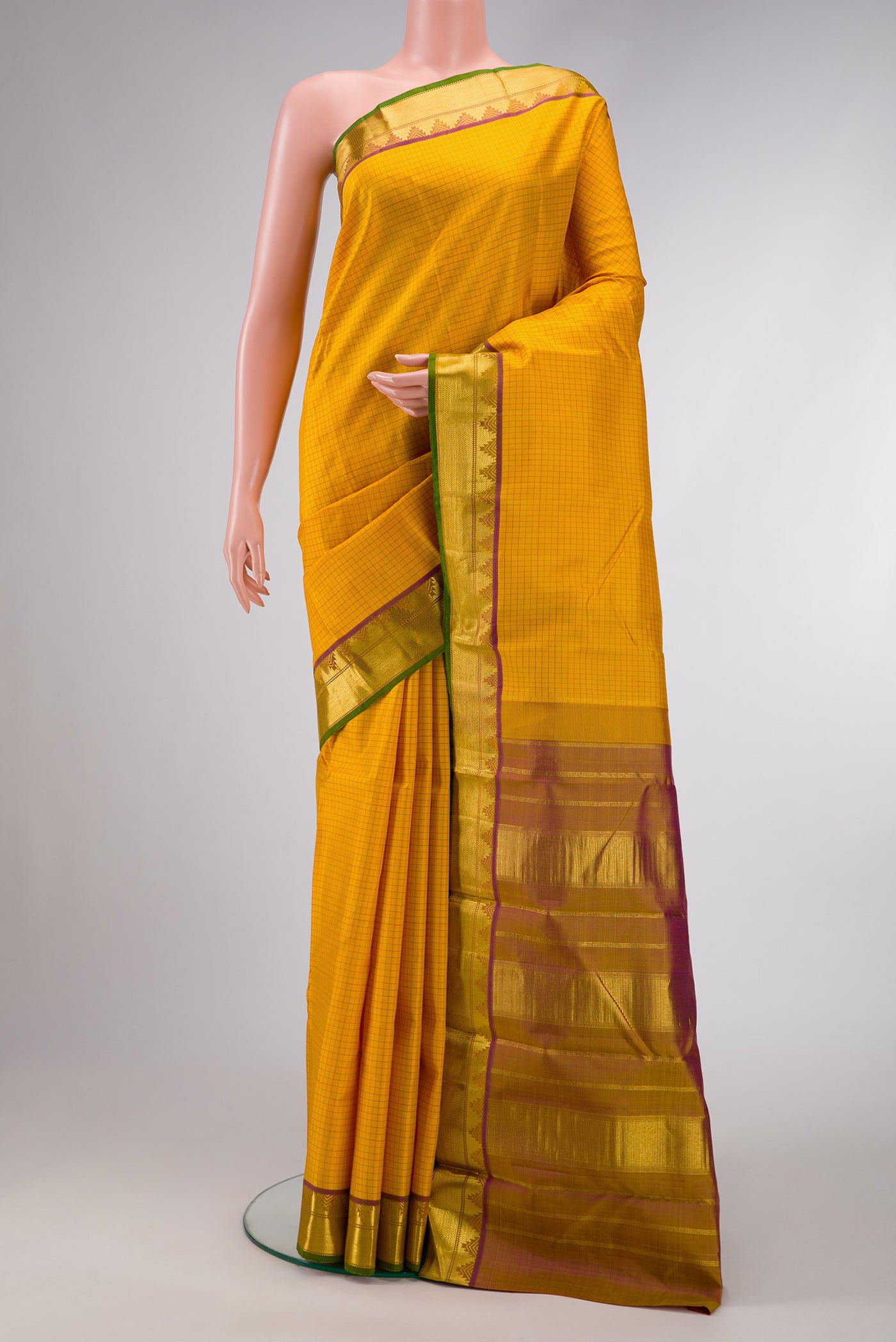 Mustard Dual Tone Kanjivaram Silk Saree with Checked design on the body and Zari Border.  displayed on a mannequin