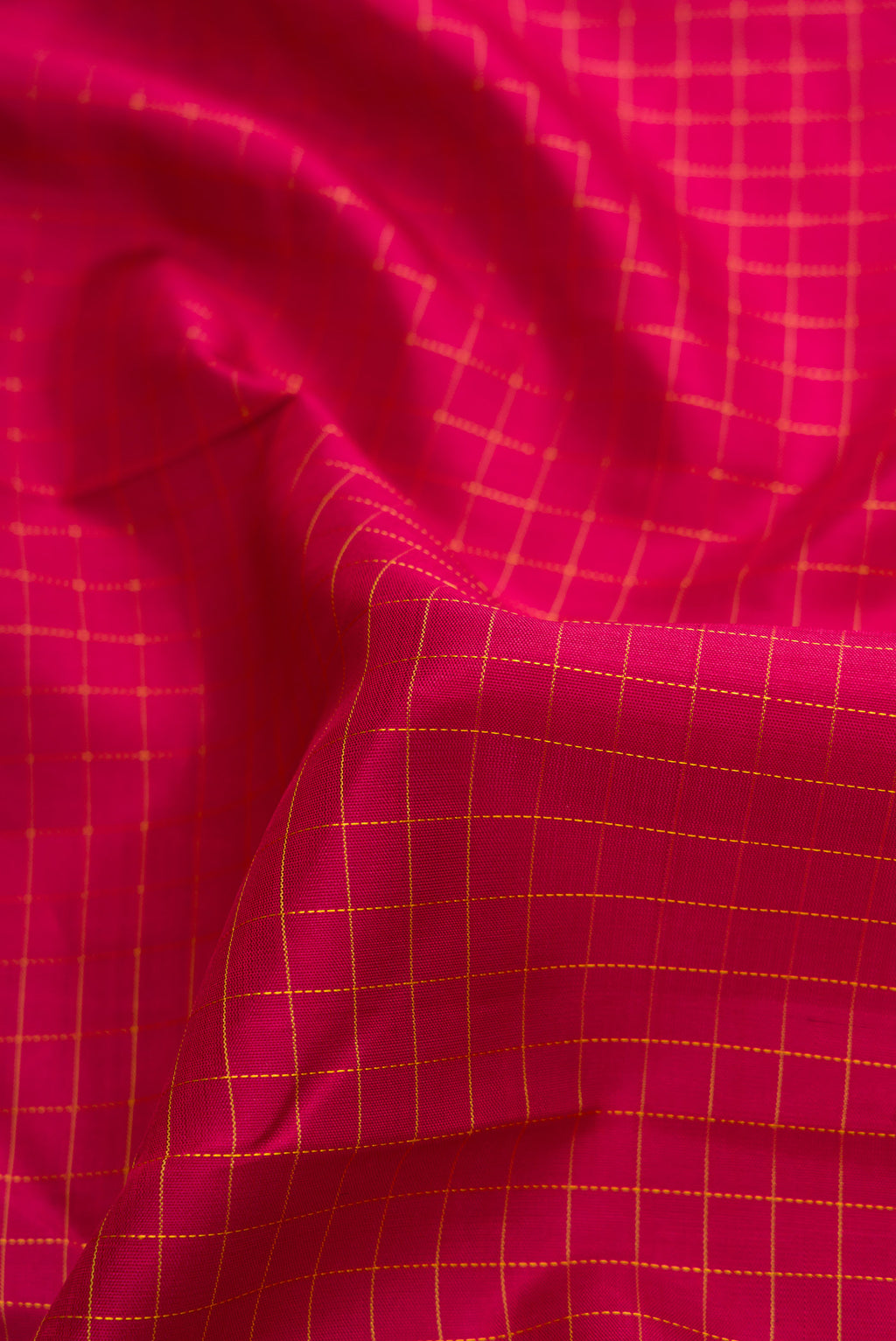 Close up of Maroon Dual Tone Kanchipuram Silk Saree with Checked design on the body and Zari Border.  displaying folds