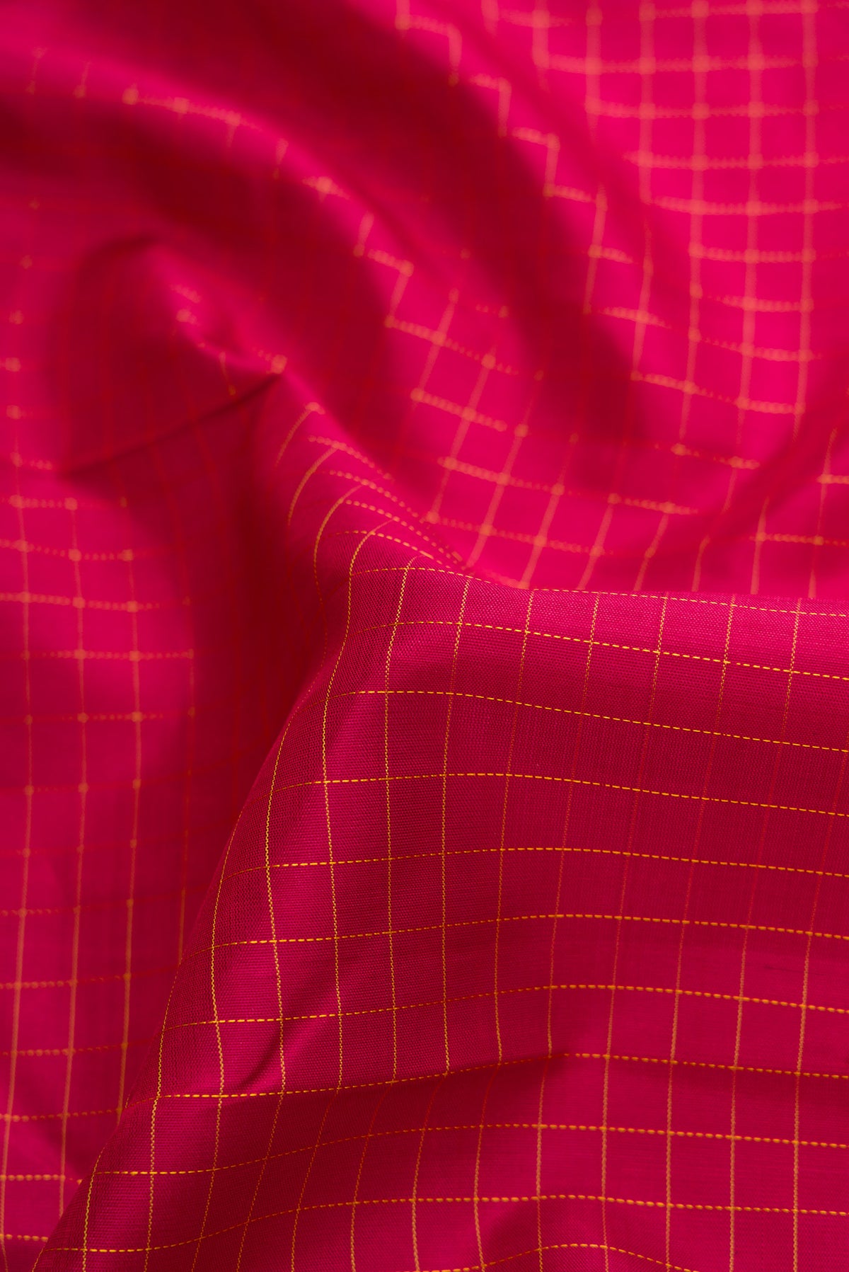 Close up of Maroon Dual Tone Kanchipuram Silk Saree with Checked design on the body and Zari Border.  displaying folds