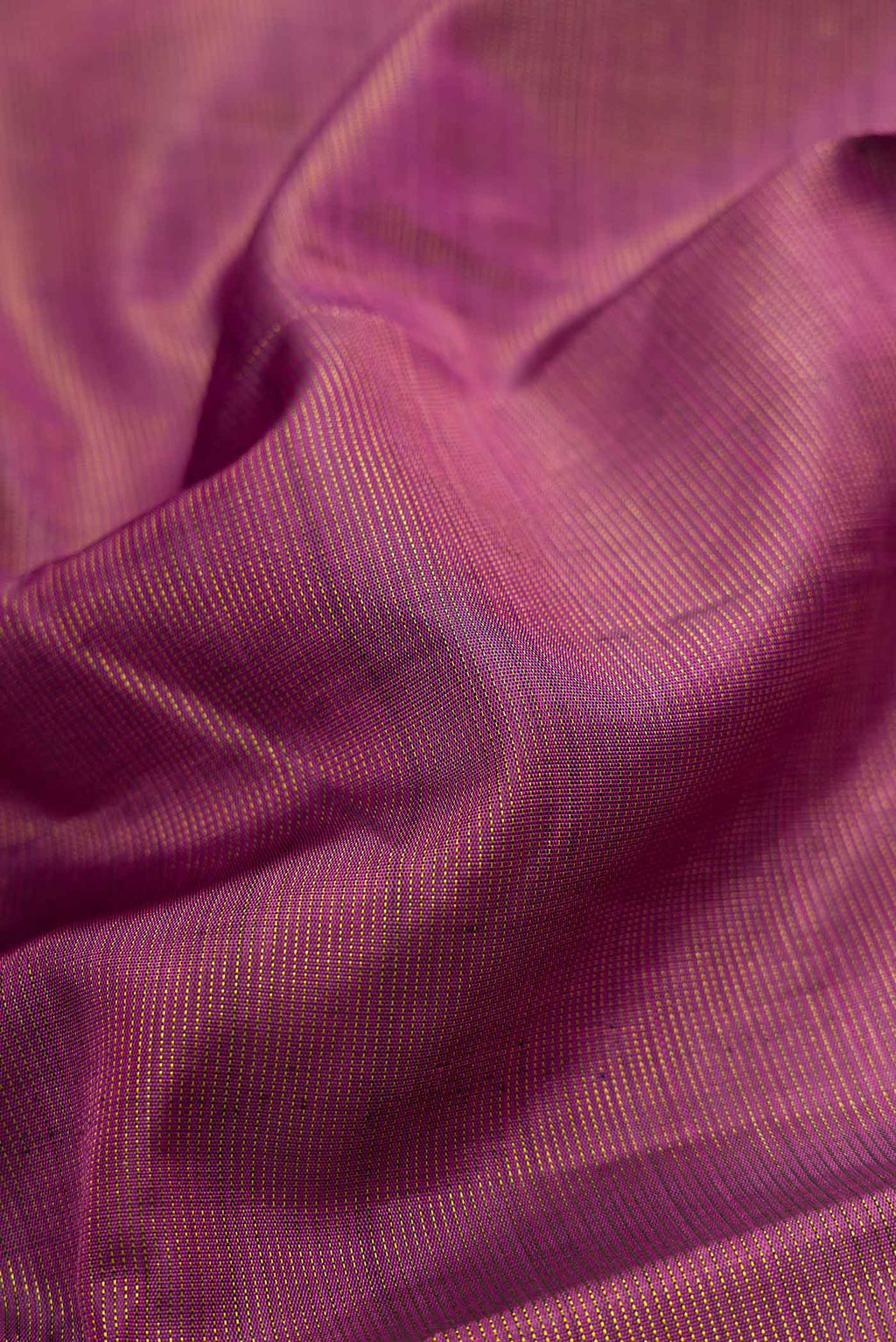 Close up of Pink Dual Tone Kanjivaram Silk Saree with Zari Butta on the body and Zari Border.  displaying folds
