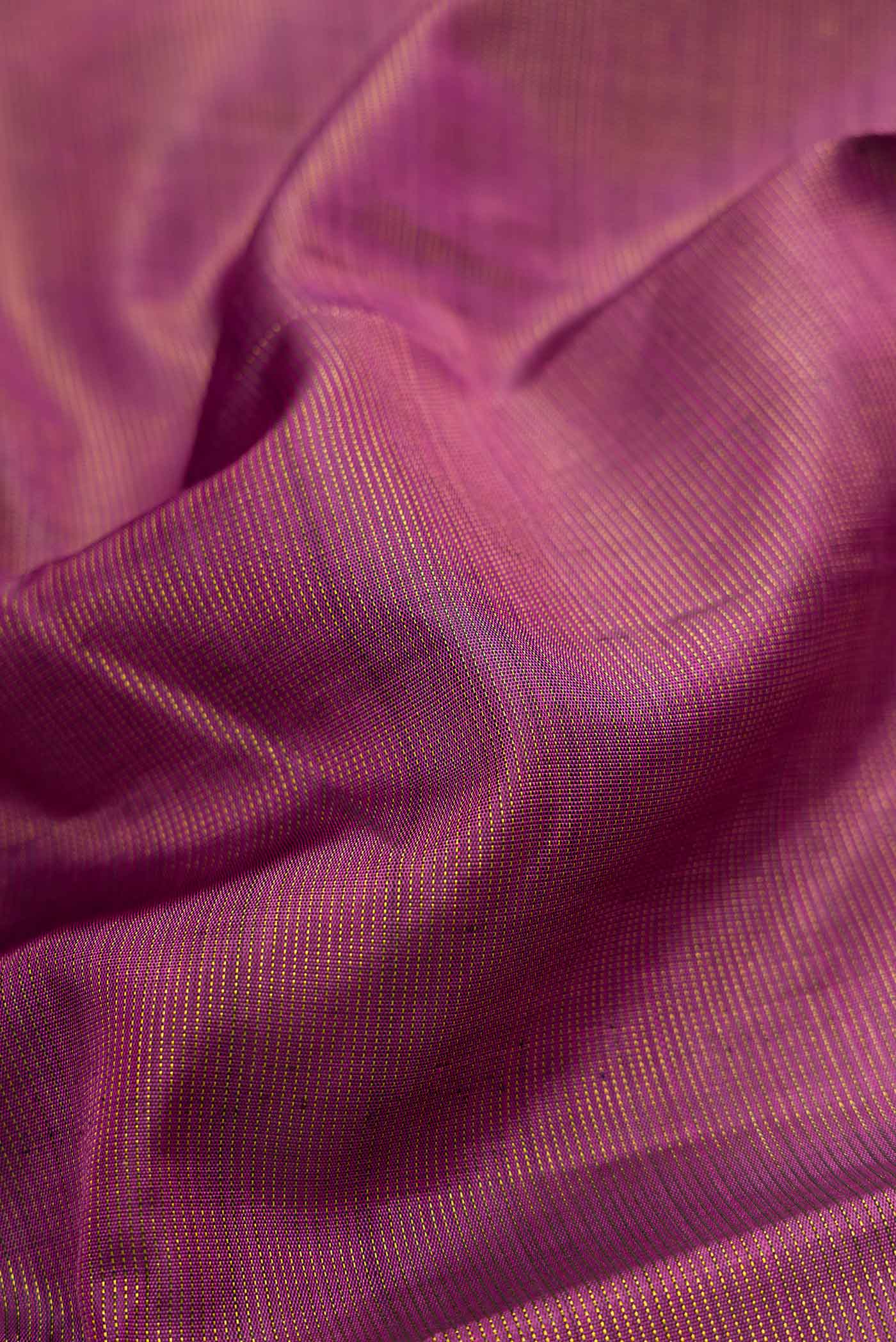 Close up of Pink Dual Tone Kanjivaram Silk Saree with Zari Butta on the body and Zari Border.  displaying folds