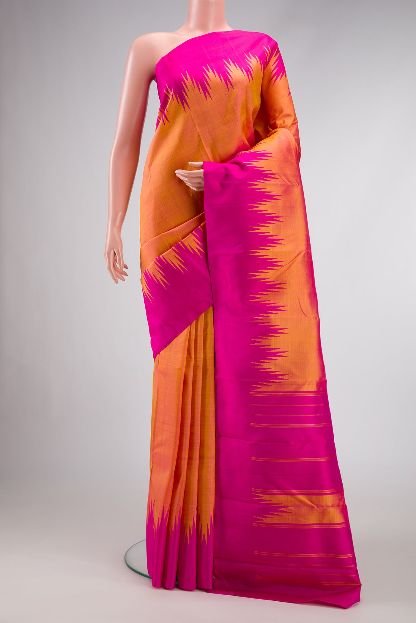 Orange Dual Tone Kanchipuram Silk Saree with Plain Body and Temple Border.  displayed on a mannequin