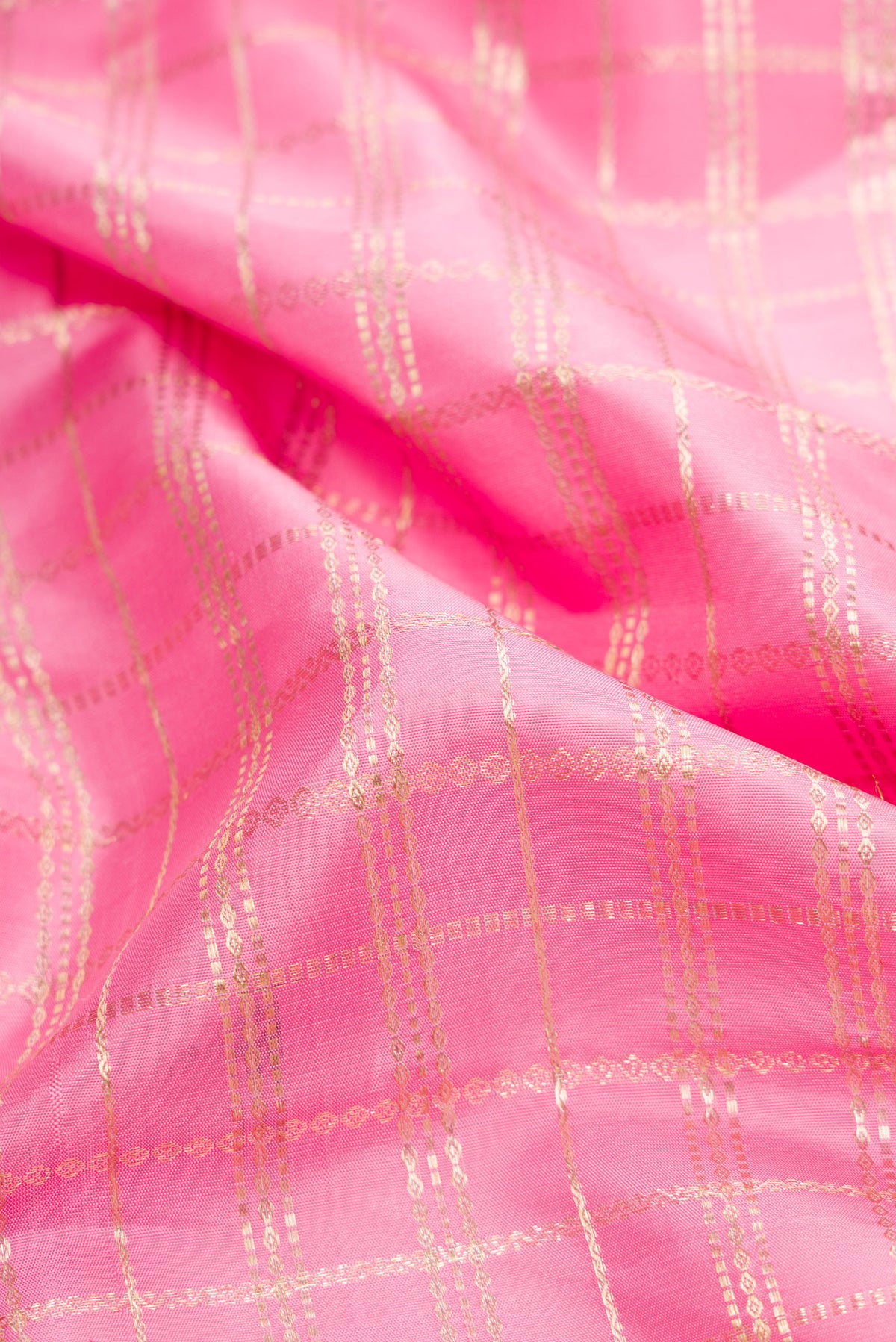 Close up of Pink Dual Tone Kanjivaram Silk Saree with Checked design on the body and Zari Border.  displaying folds