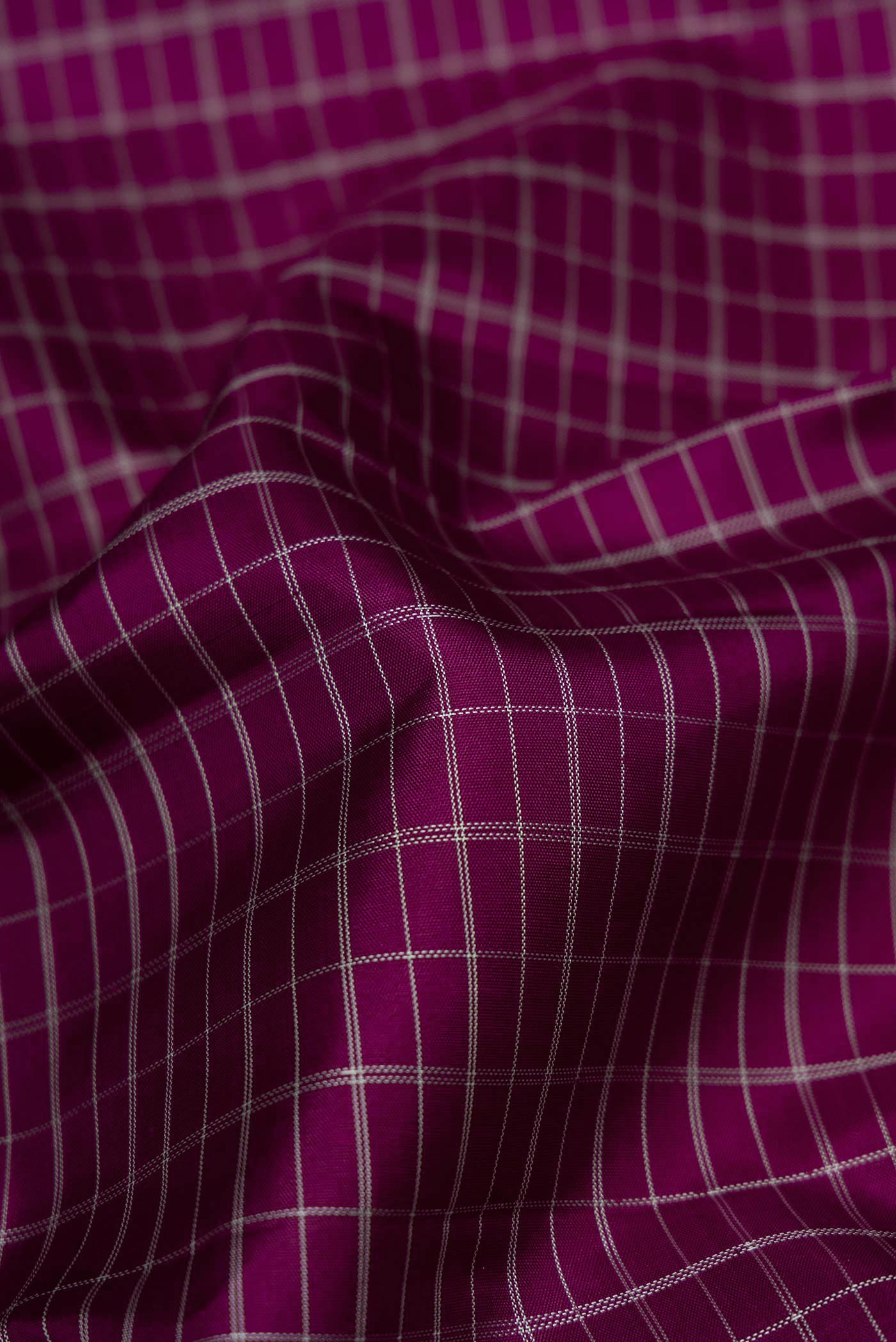Close up of Pure Silk Pure Zari Purple Dual Tone Kanjivaram Saree with Checked design on the body and Zari And Thread Border.  displaying folds