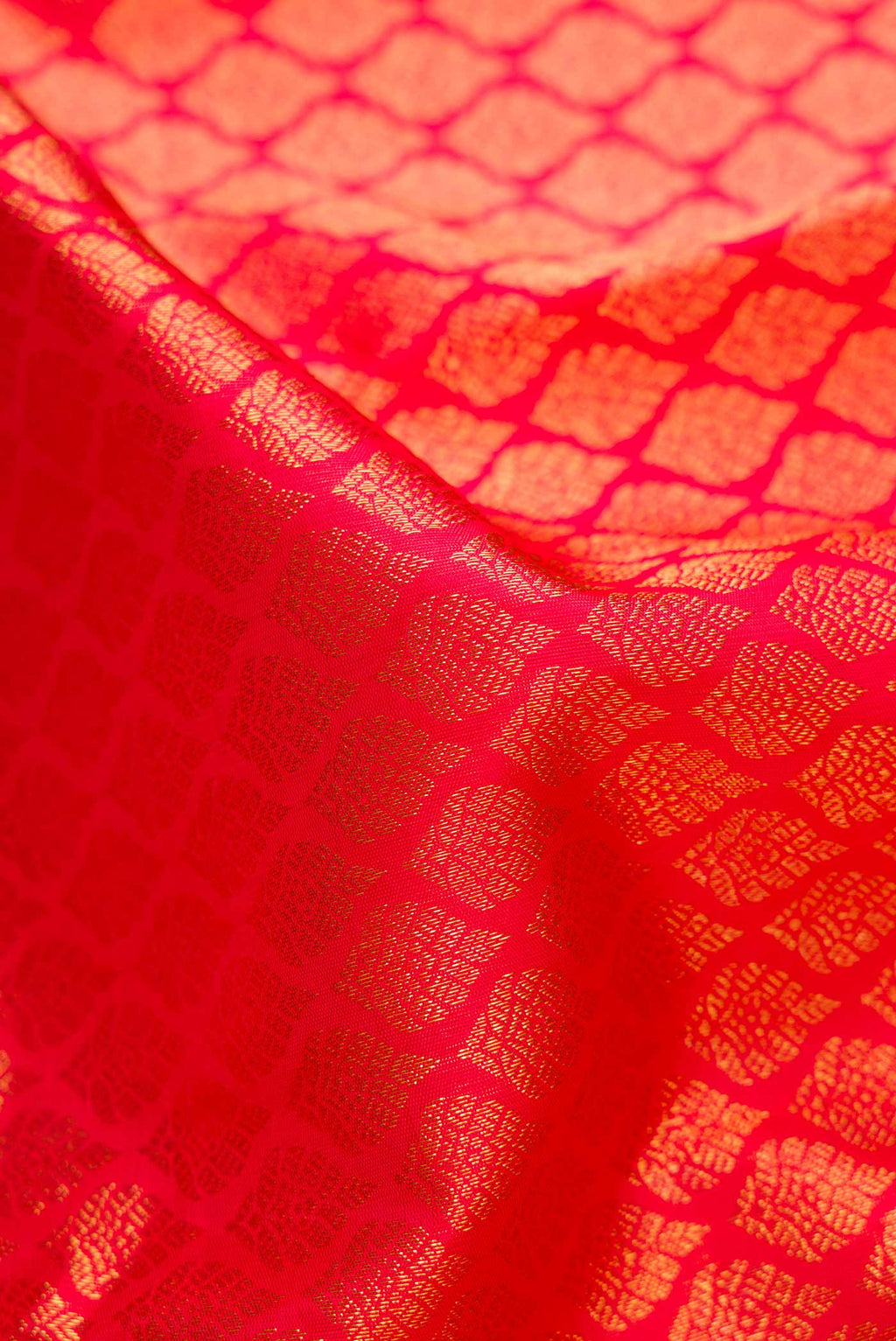 Close up of Pure Silk Pure Zari Pink with Red Color Kanchipuram Saree with Zari Brocade on the body and Zari Border displaying folds