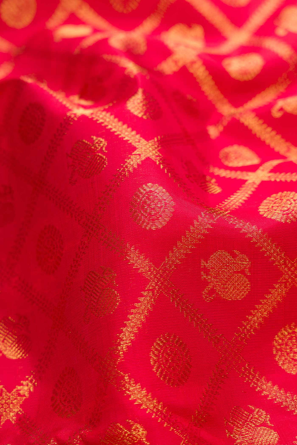 Close up of Pure Silk Pure Zari Red Dual Tone Kanchipuram Saree with Zari Brocade on the body and Zari Border displaying folds